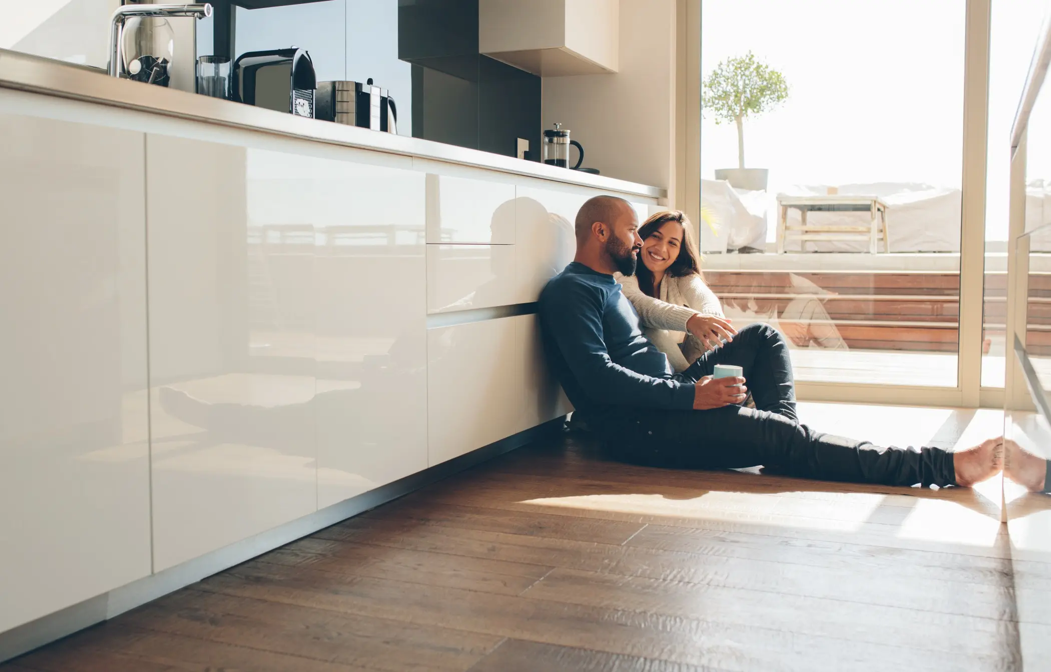 Couple sitting on kitchen floor