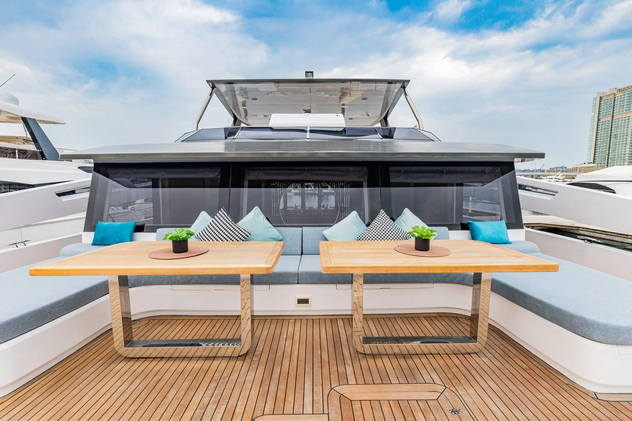 Zirve 72 yacht front deck seating with wooden tables and comfortable cushions
