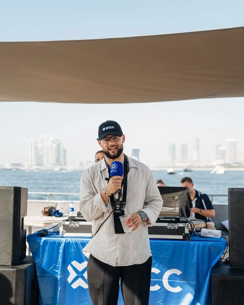 Event host speaking during a corporate yacht event in Dubai
