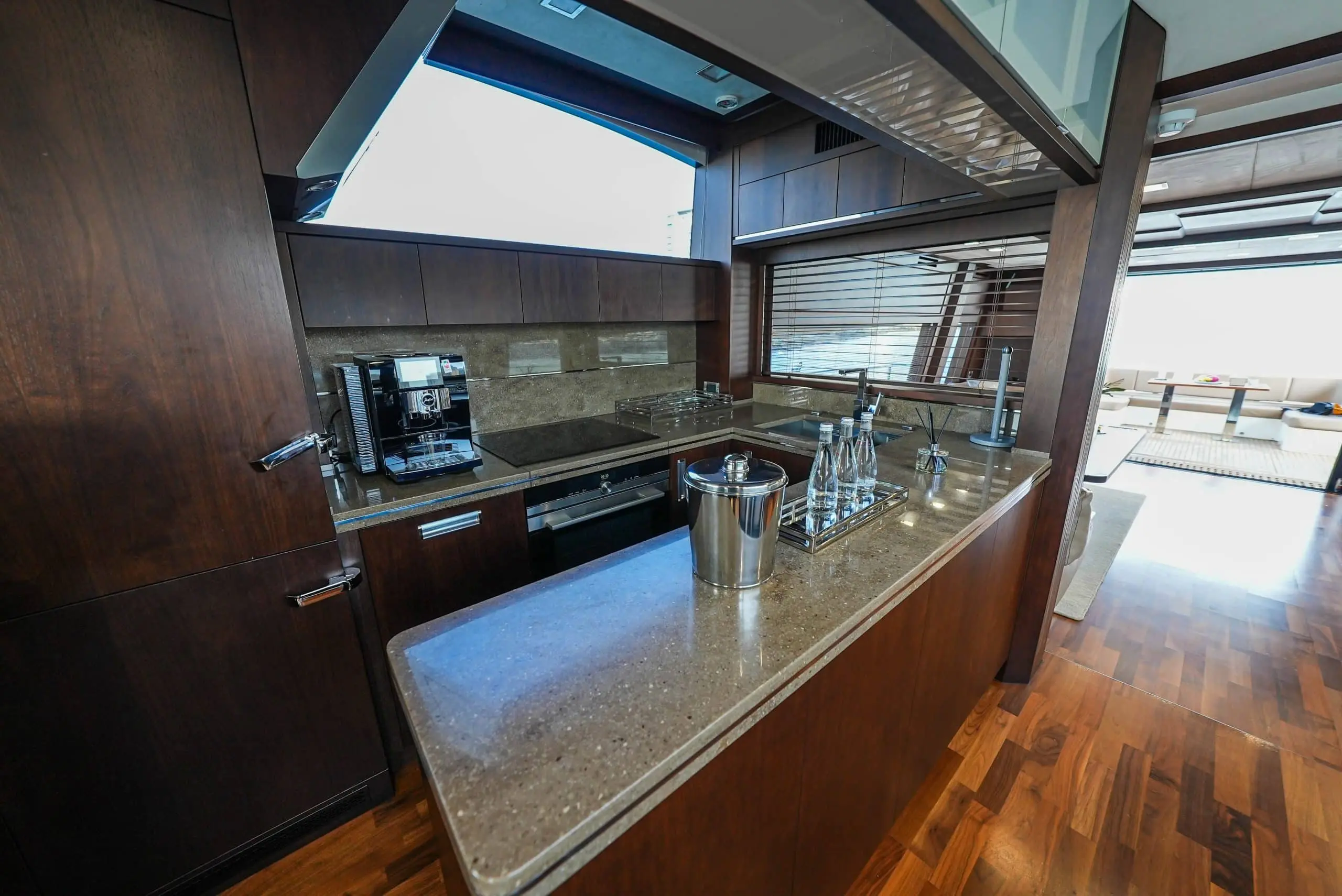 Galeon 780 F1 interior bar and galley area with wood cabinetry and large windows
