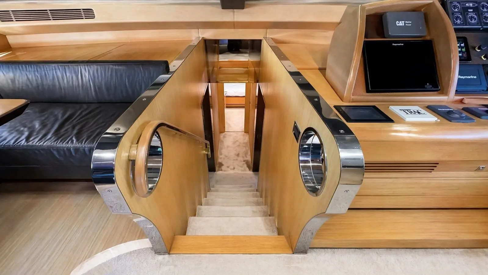 Azimut 88 companionway stairs beside the polished helm console