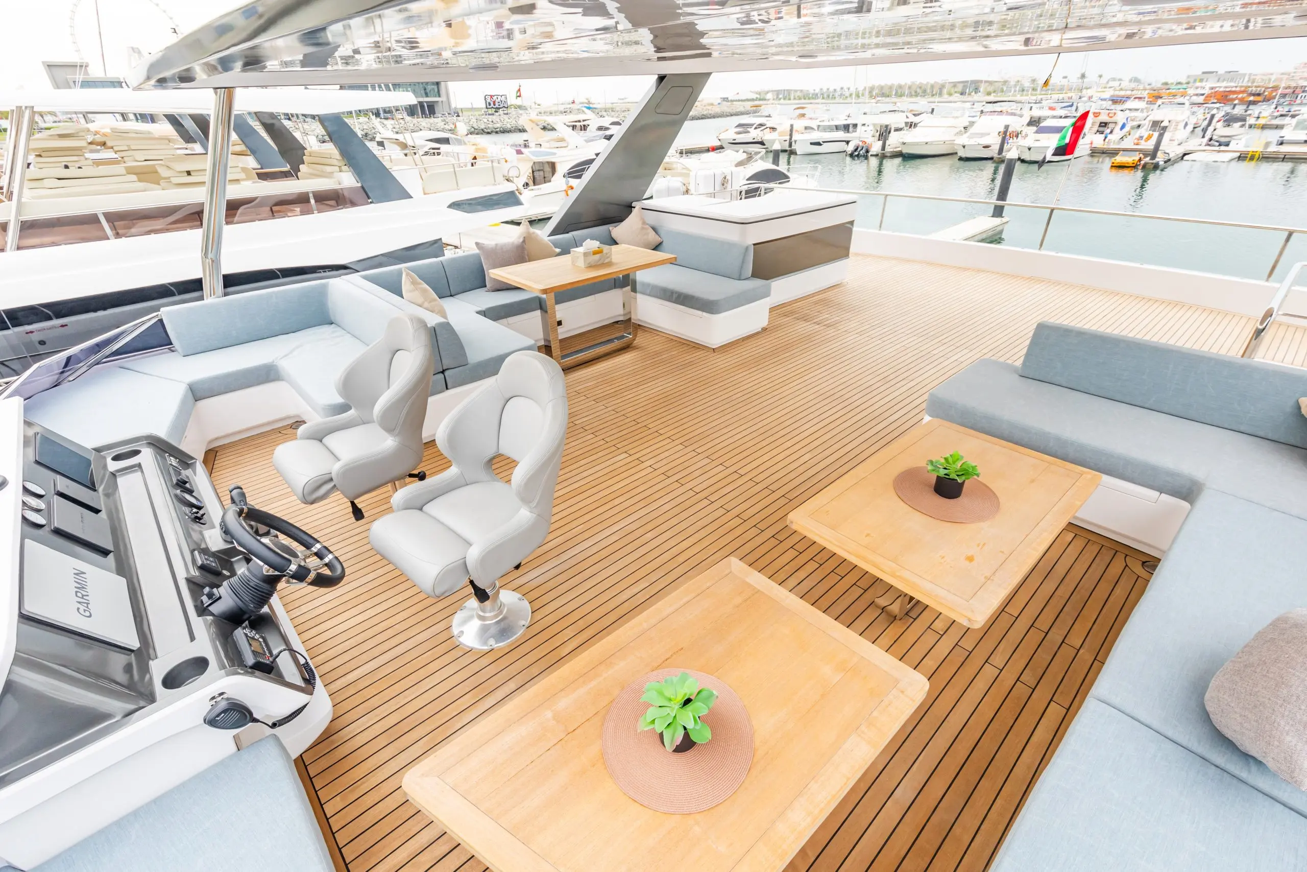 Luxury flybridge seating and helm area on the Zirve 72 yacht with wooden deck and ocean view