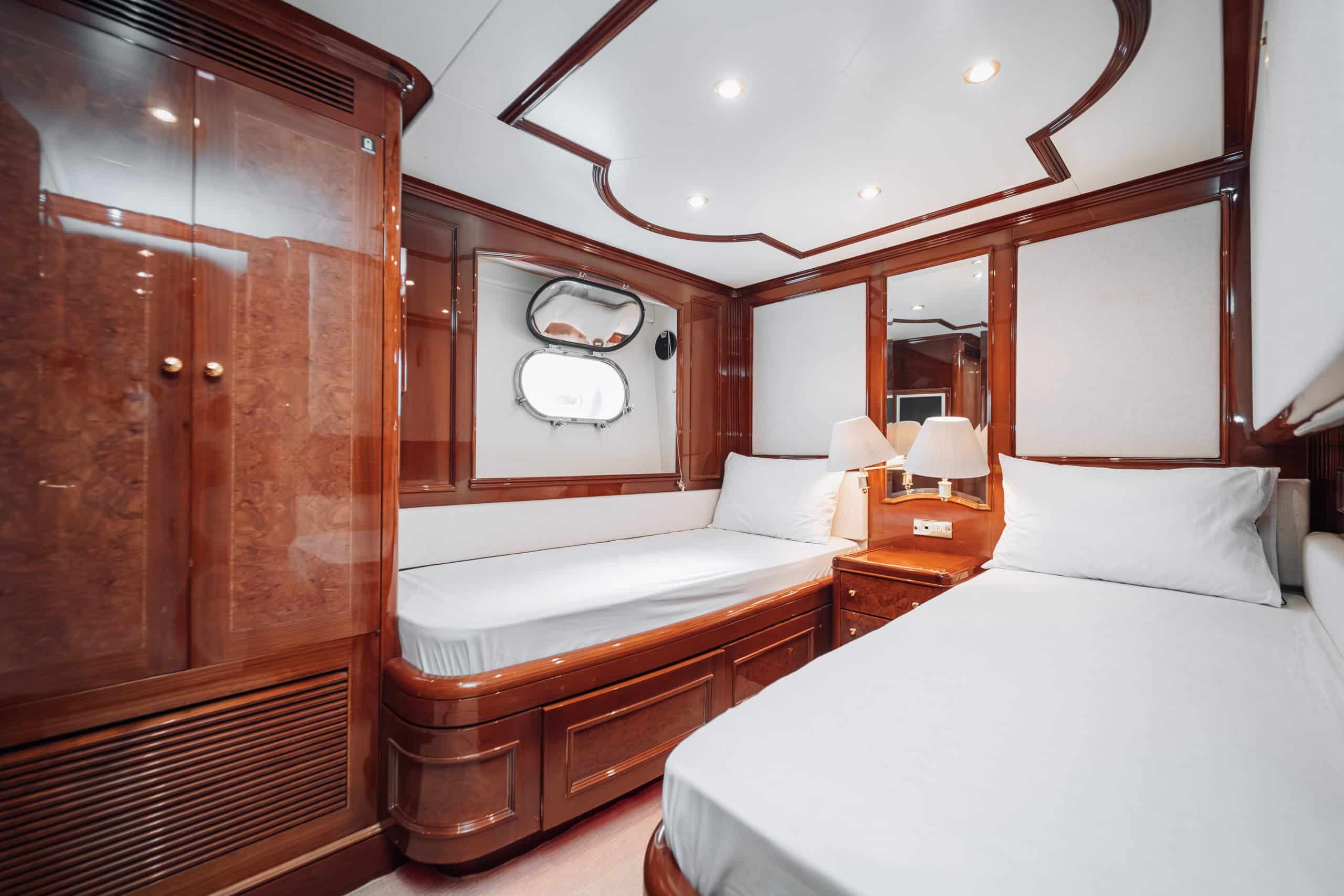 Royal Mirage yacht guest cabin with built-in seating and storage