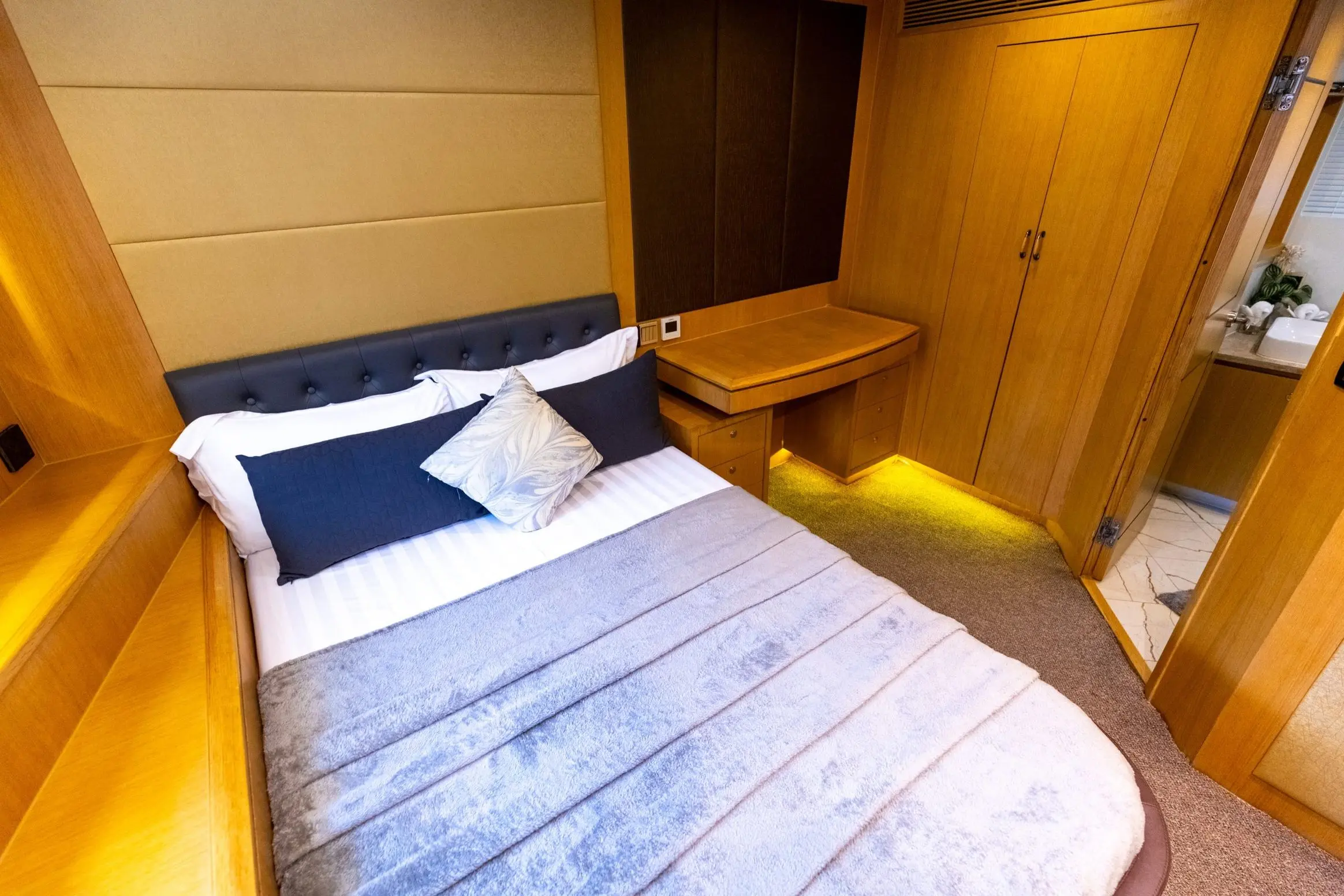Asya 110 yacht VIP bedroom with double bed and wooden cabinetry