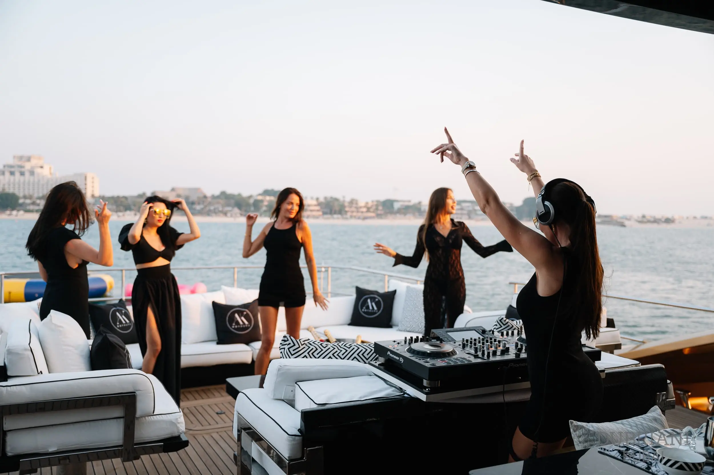 Group of women enjoying a yacht party at sunset