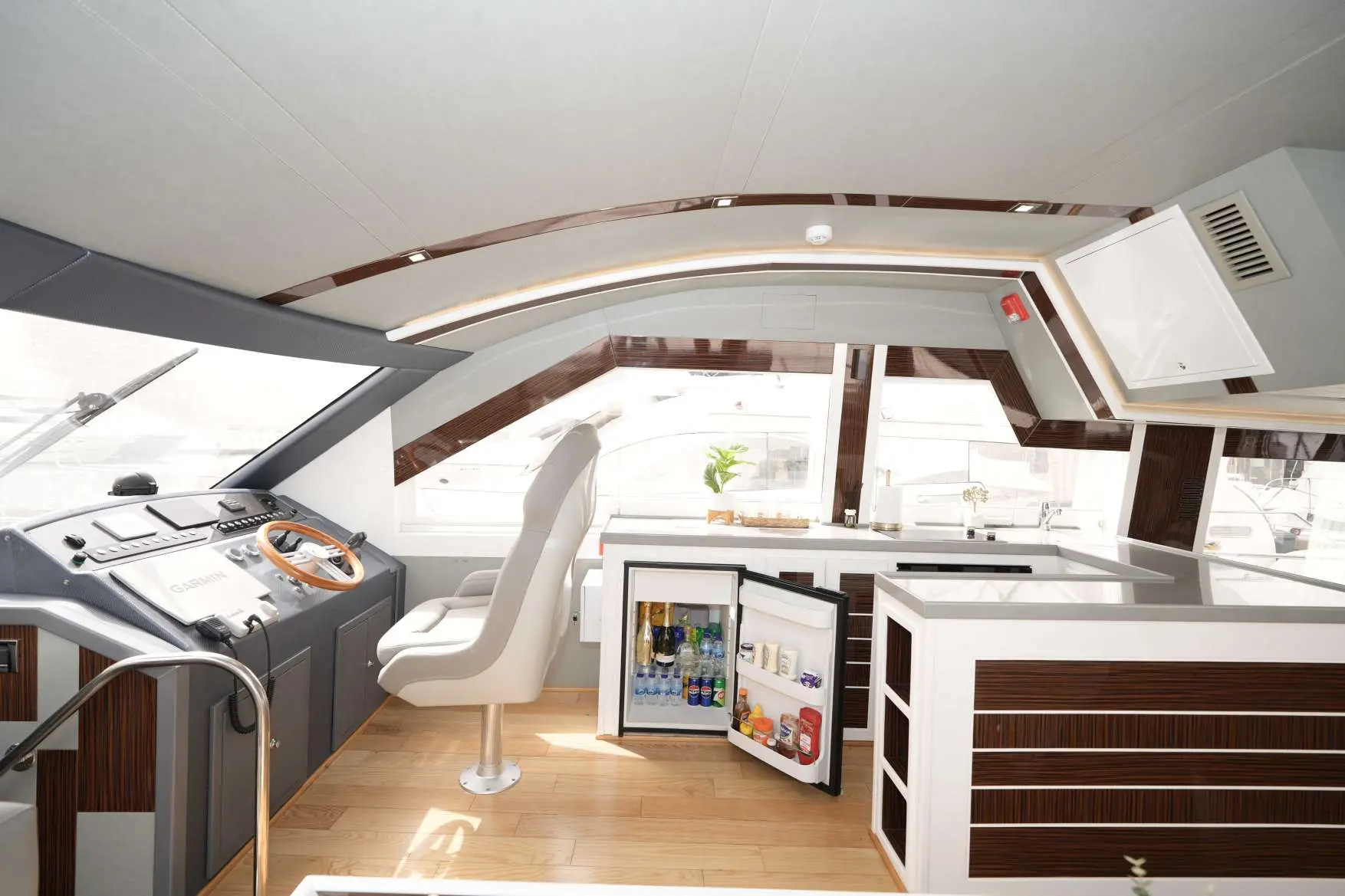 Belle 75 luxury yacht helm station interior with control panel and modern cabin design