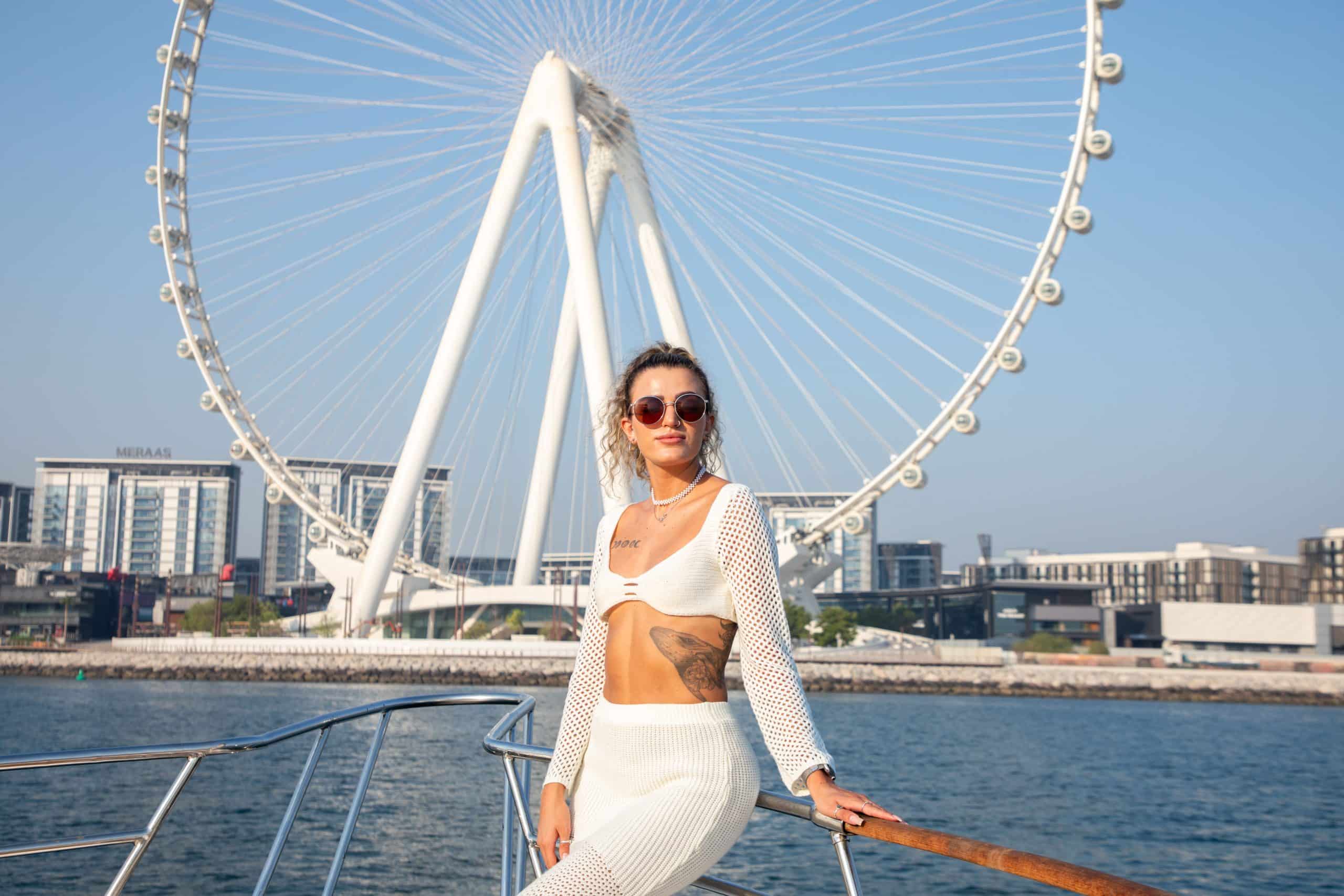 Guest enjoying yacht cruise with Ain Dubai view