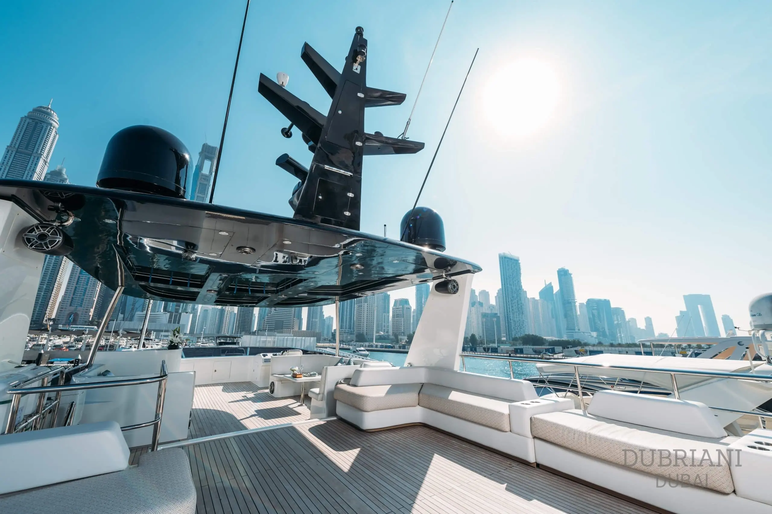 Eclipse yacht sun deck with lounge seating and city skyline in background