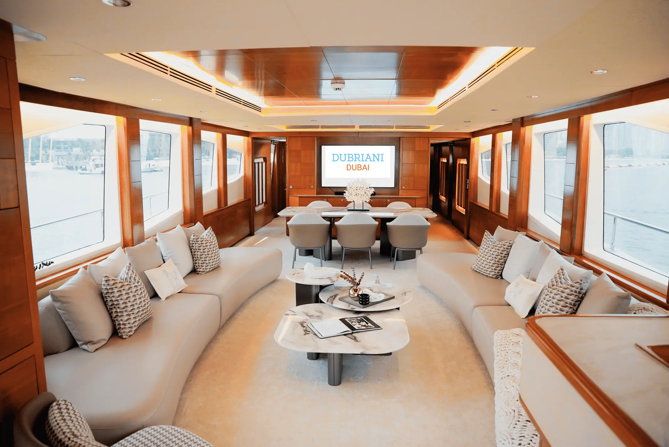 Spacious main salon lounge on Luna 101 yacht with panoramic windows at Yas Marina