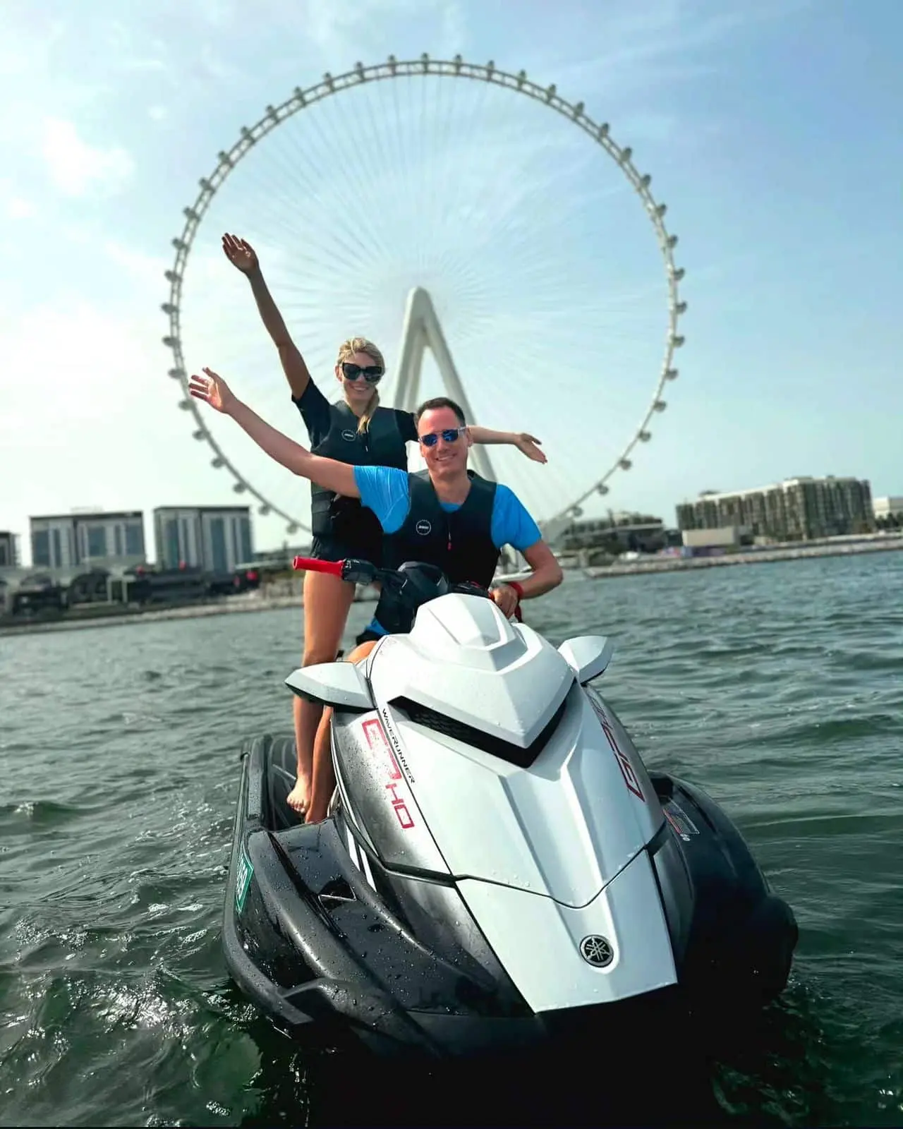 Tourist enjoying jet ski ride with Ain Dubai Ferris wheel in background