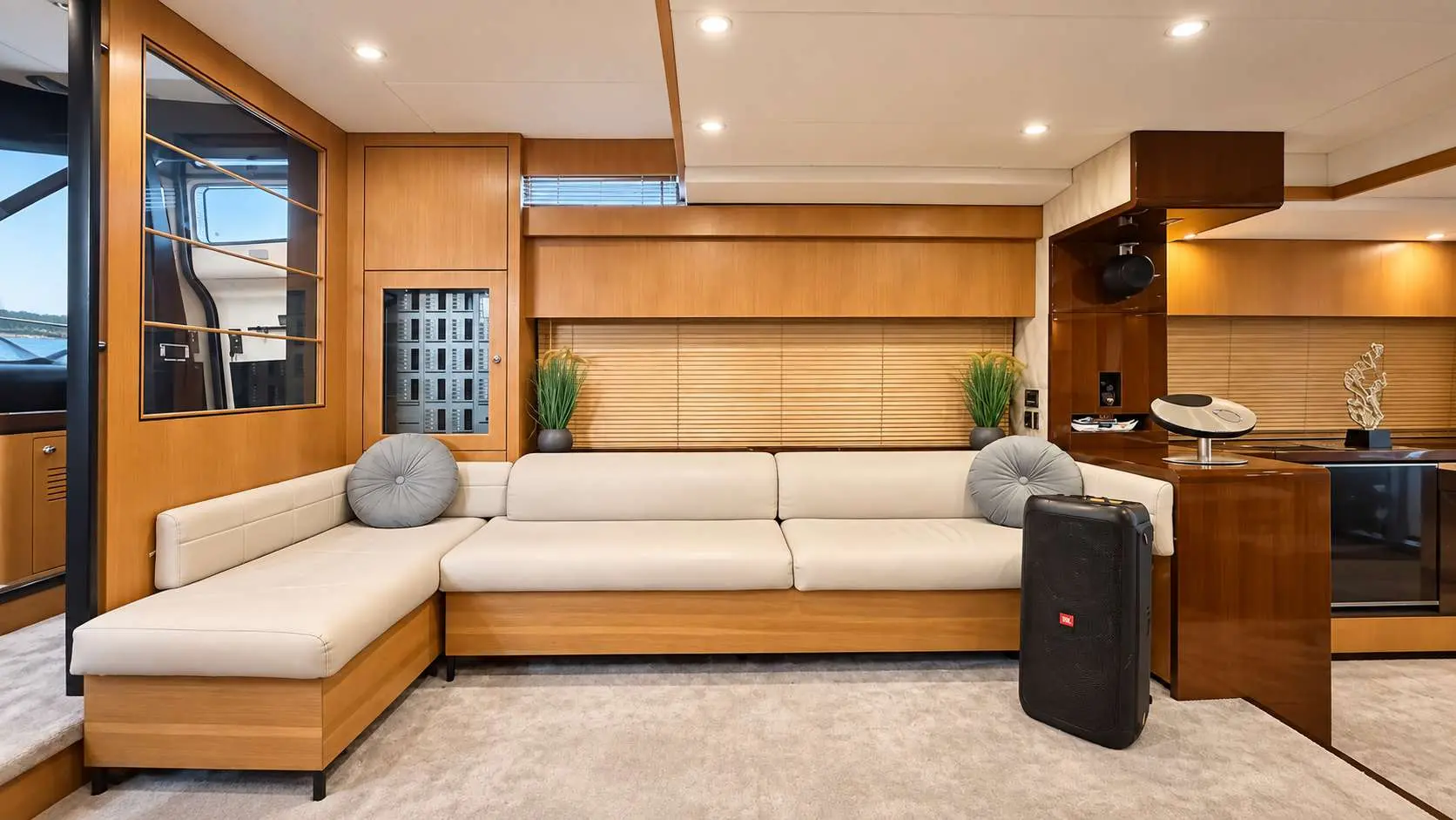 Empress 80 salon lounge with L-shaped sofa and sound system
