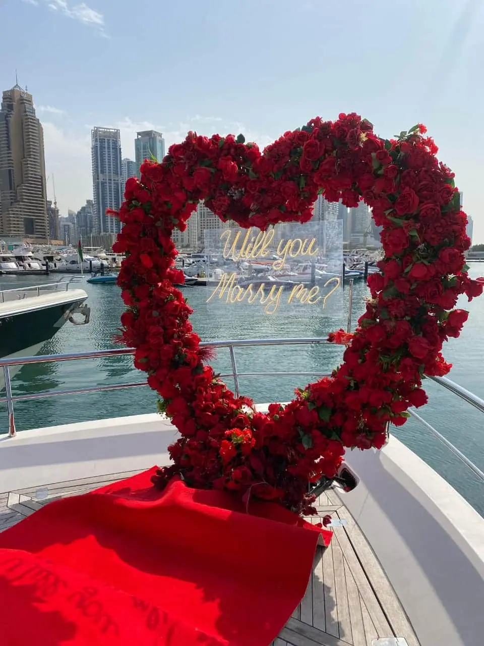 Heart-shaped red floral decoration on yacht deck for romantic proposal