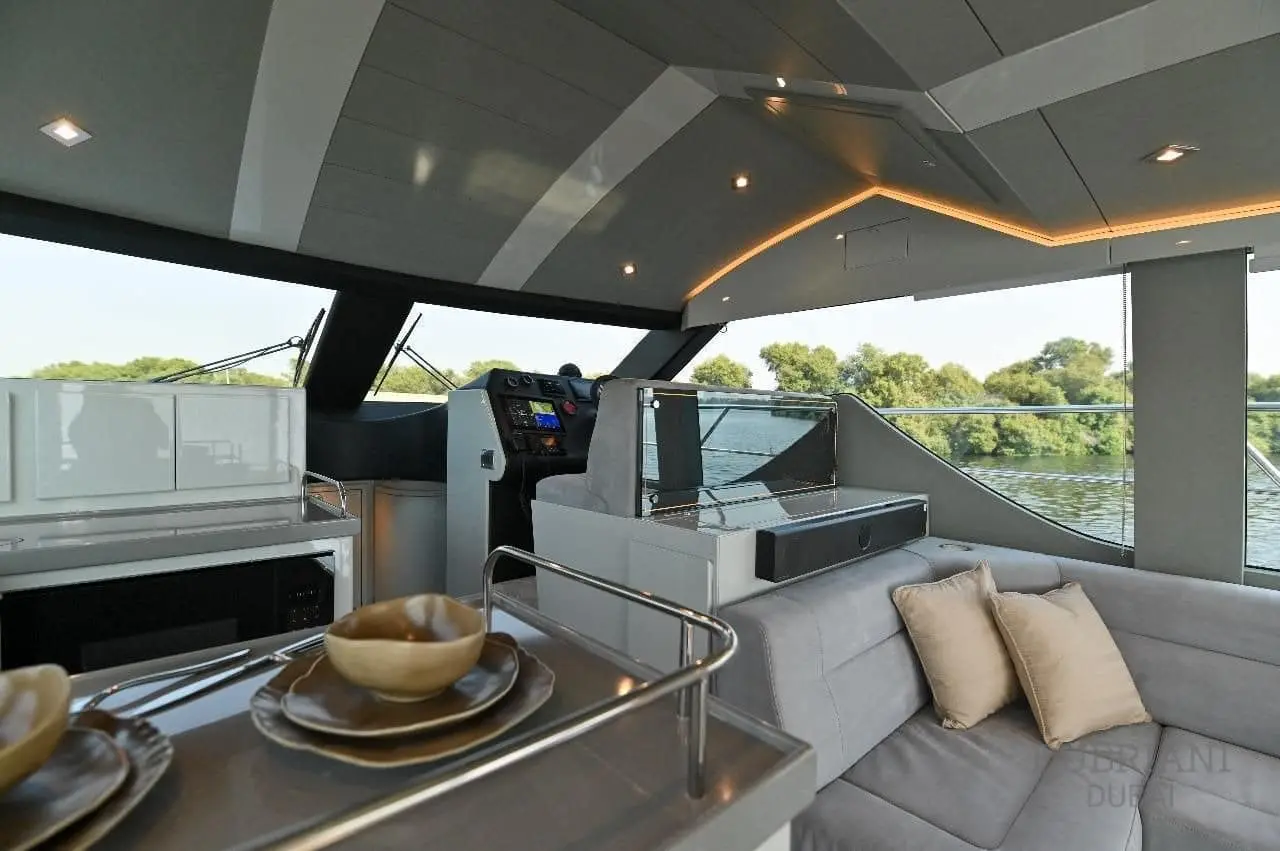 Novia 55 salon looking forward past the set galley counter to the interior helm station