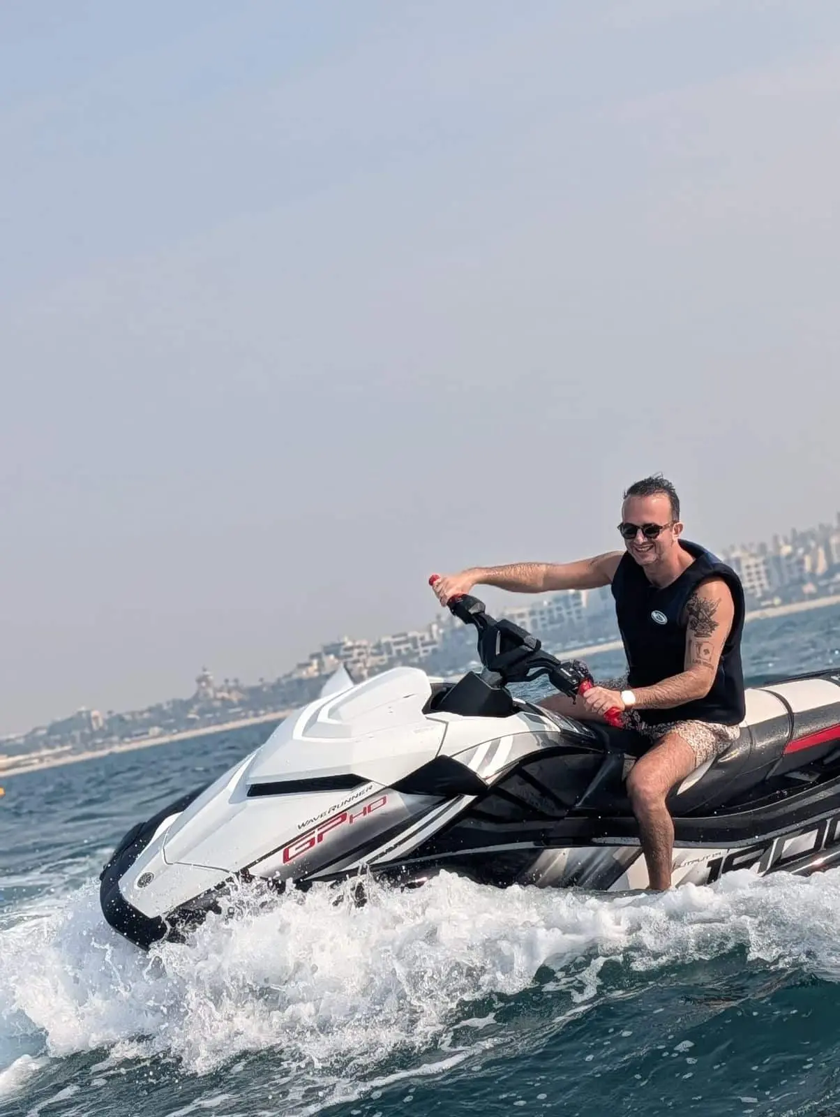 Man riding jet ski near Burj Al Arab in Dubai