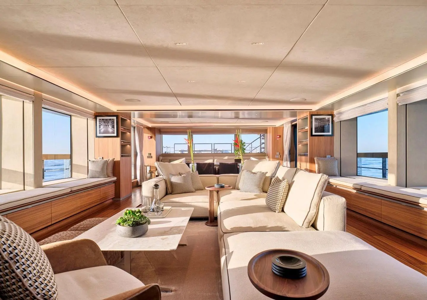 Sanlorenzo 500EXP full-beam salon with dining beyond, broker photo