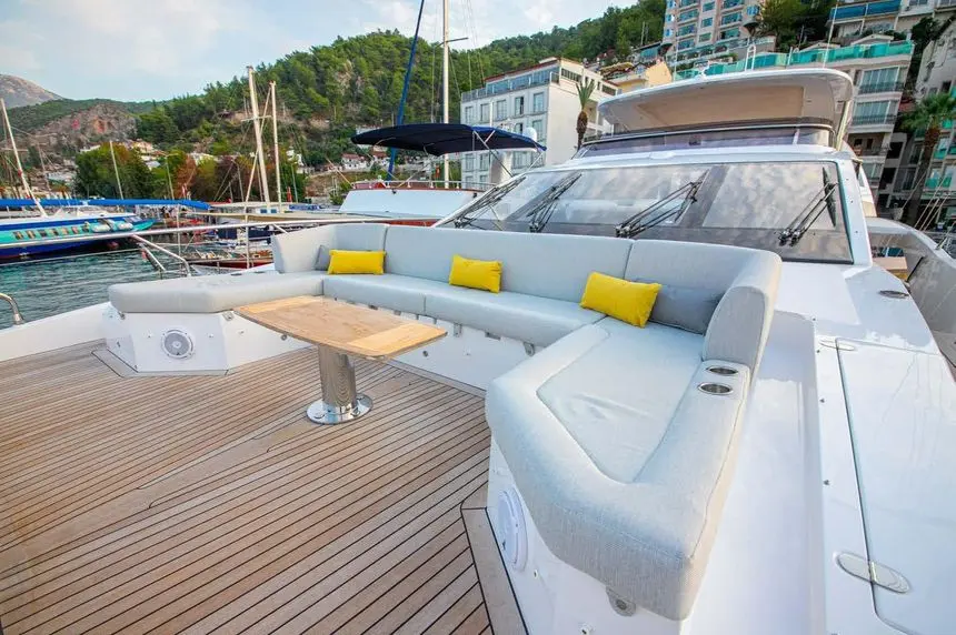 Azimut Grande 27M foredeck lounge with wraparound seating and teak table, broker photo