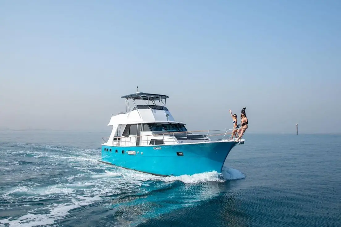 Luxury yacht cruising on clear blue waters in Dubai