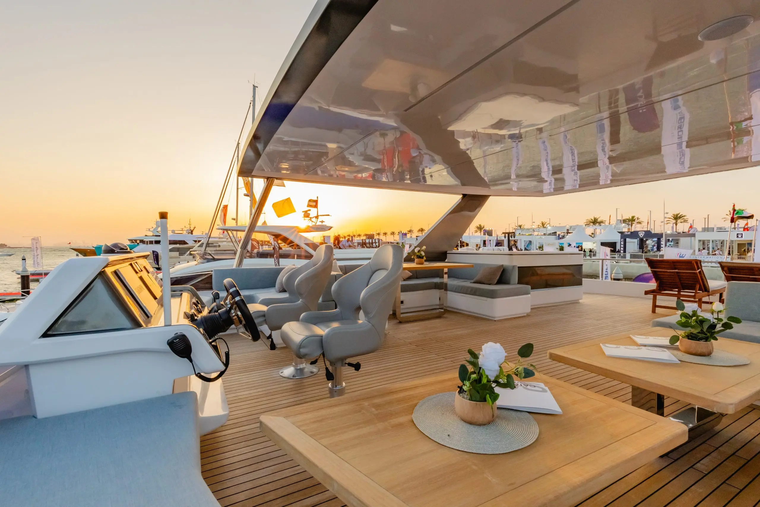 Evening view of the Zirve 72 yacht’s upper deck with warm lighting and elegant seating