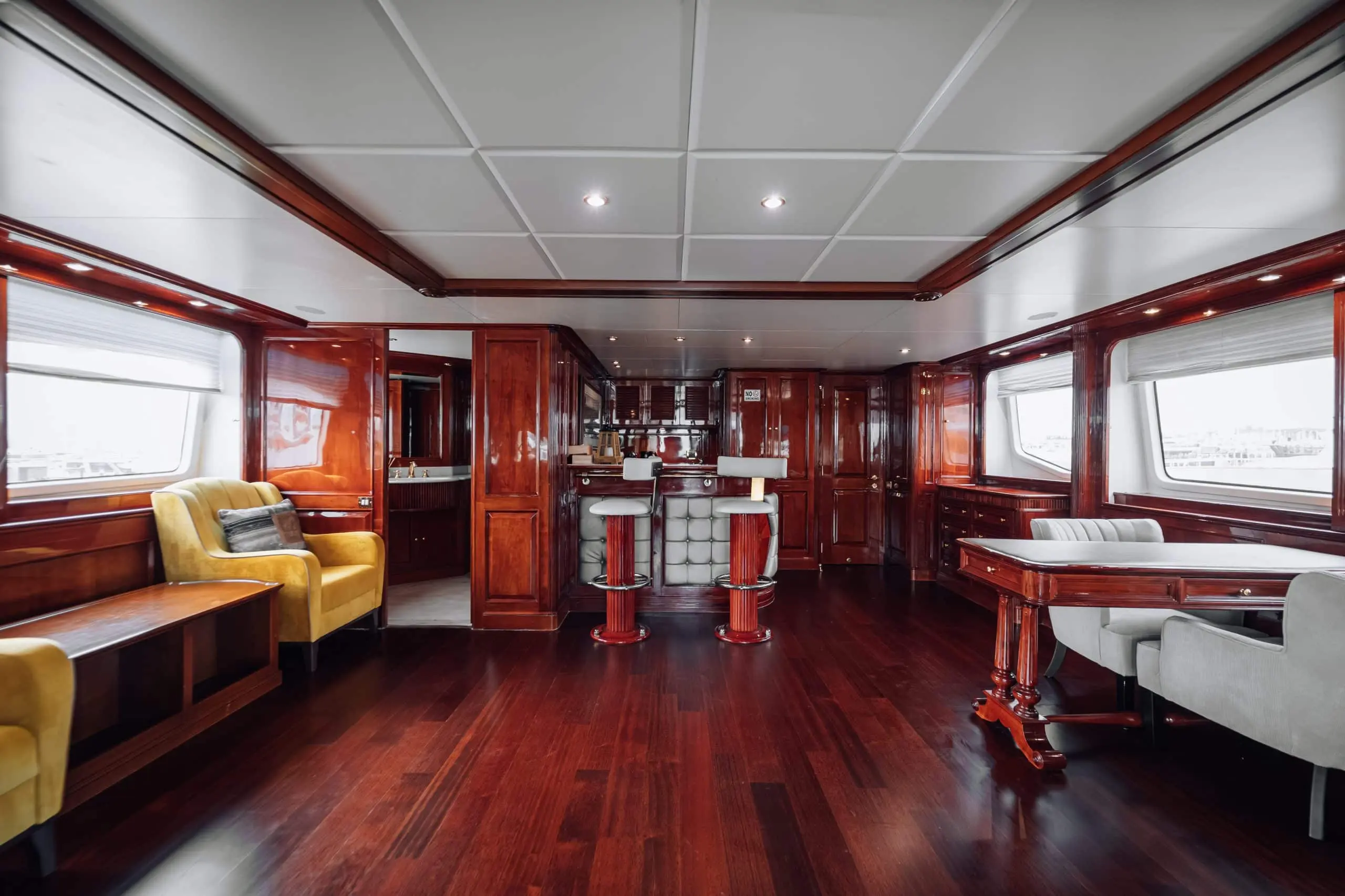 Royal Mirage yacht main salon with leather sofas and entertainment system