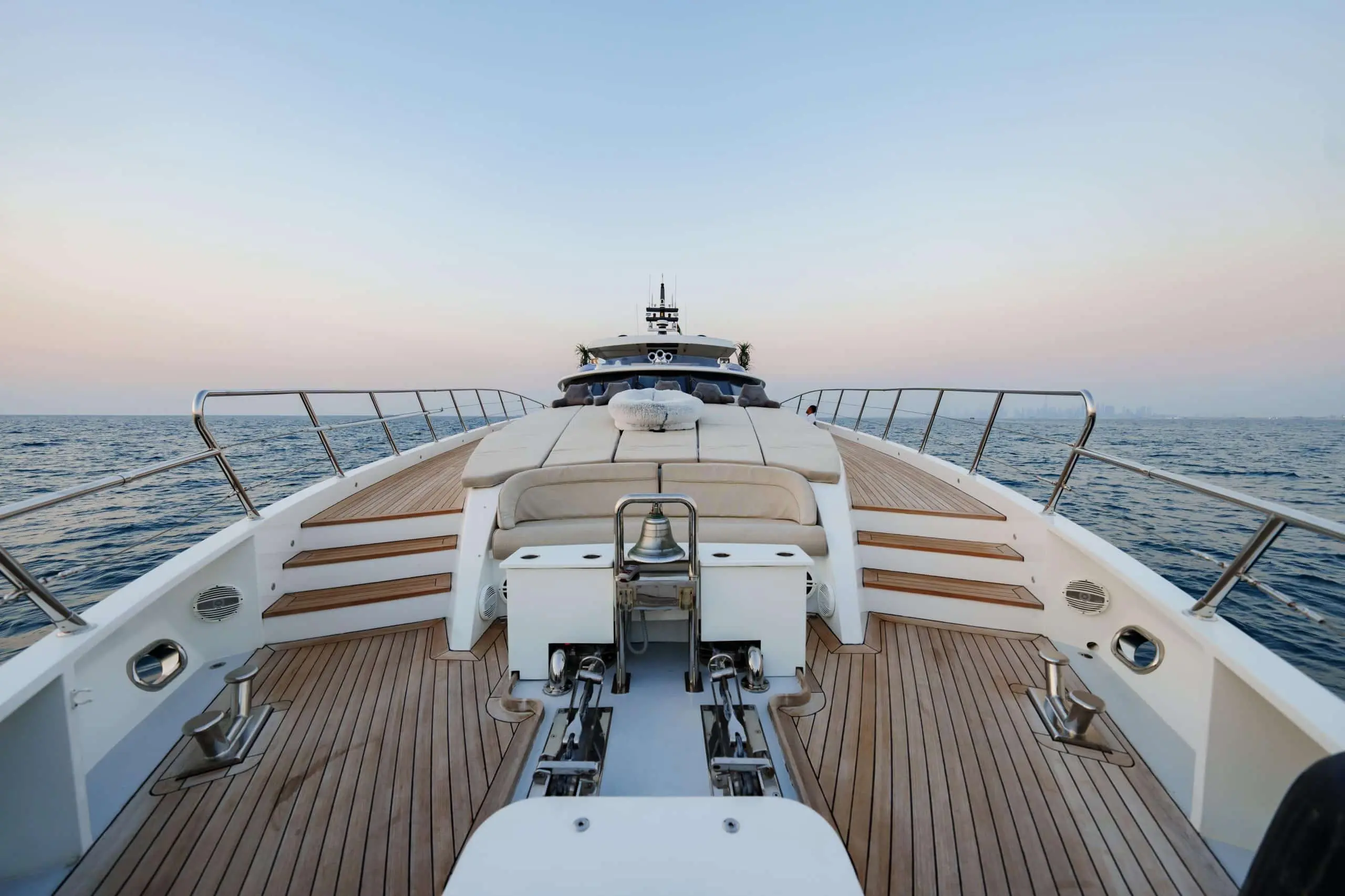 Tatti 110 yacht bow deck with sun loungers and teak flooring
