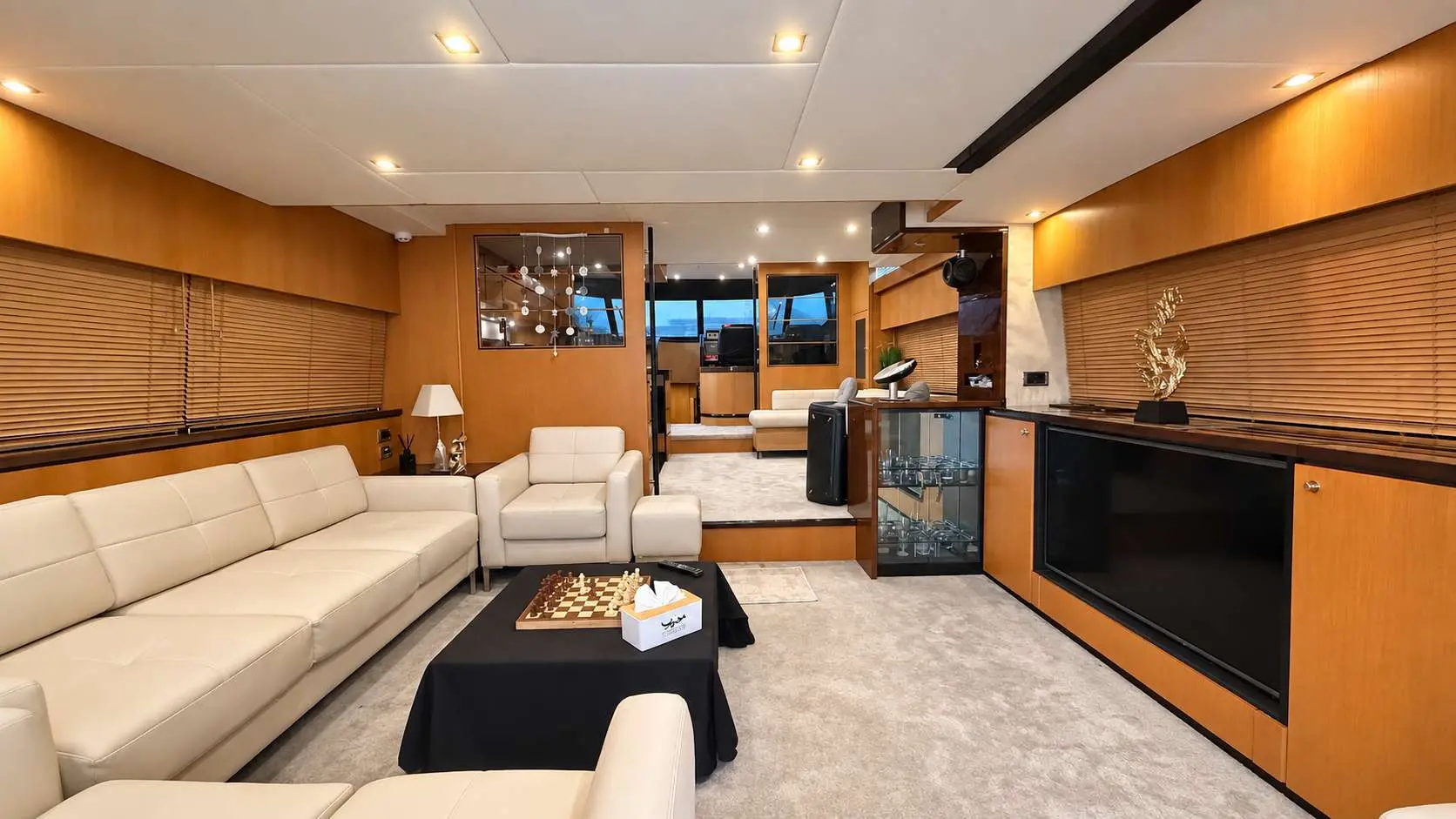 Empress 80 main salon with cream leather seating and bar