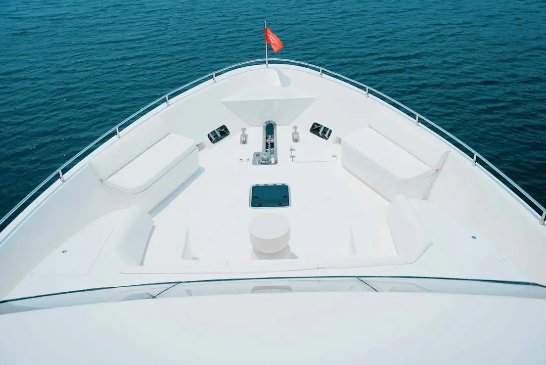 Carina 75 yacht bow seating and sun pad area overlooking calm blue water