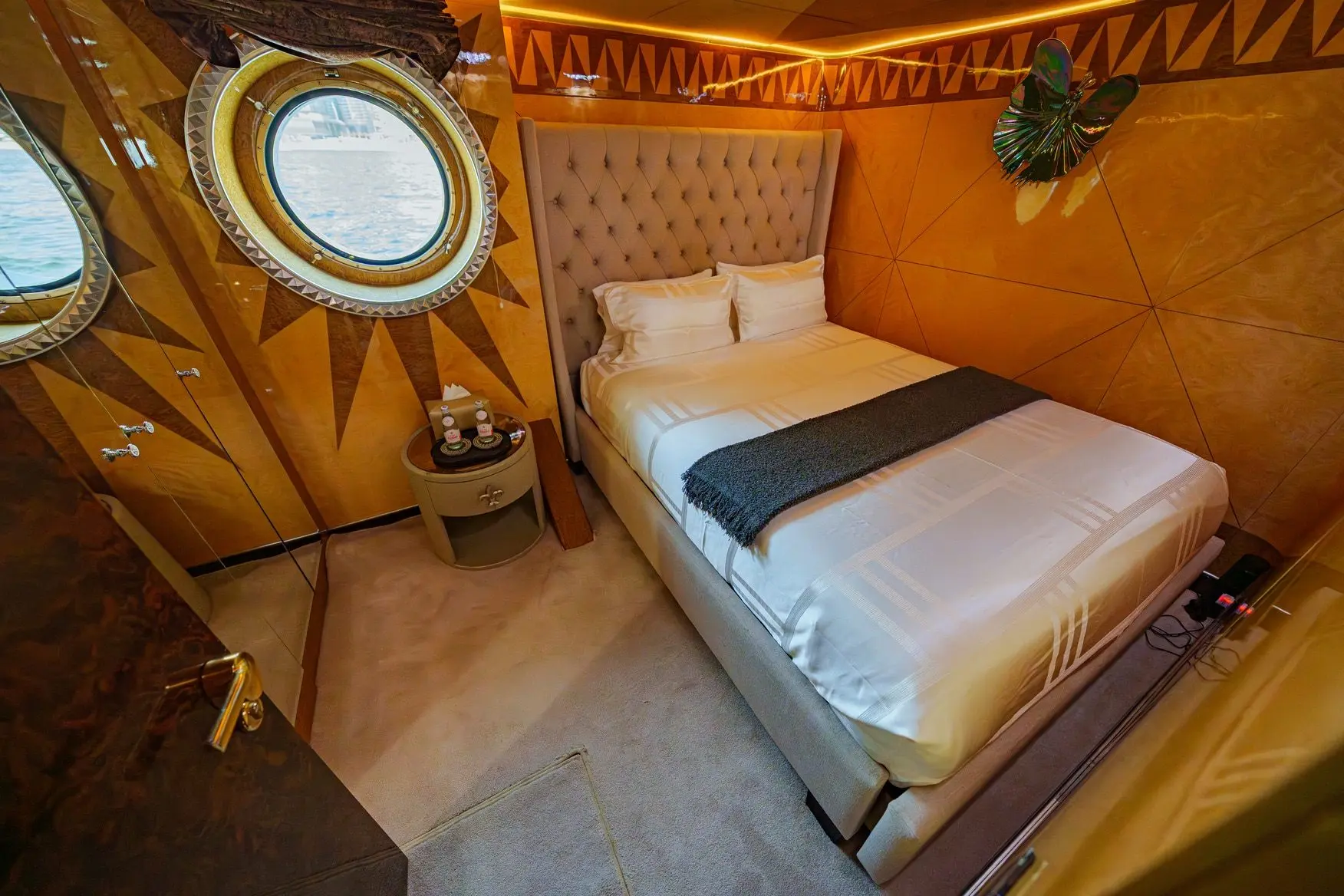 Thunder Superyacht guest cabin with soft lighting and wooden finish