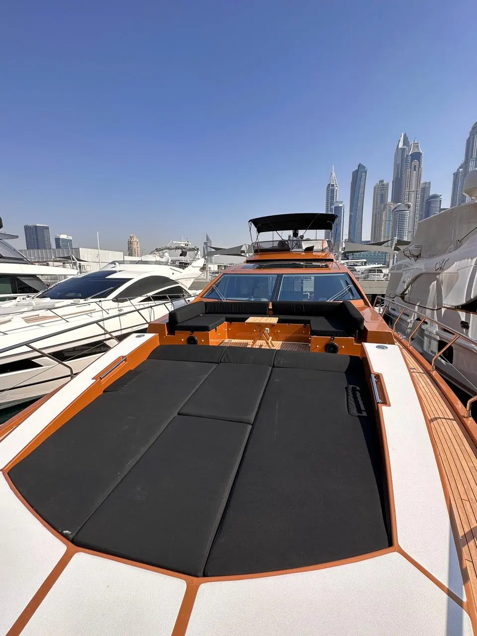 Azimut 77 yacht foredeck sunbed area with marina skyline background