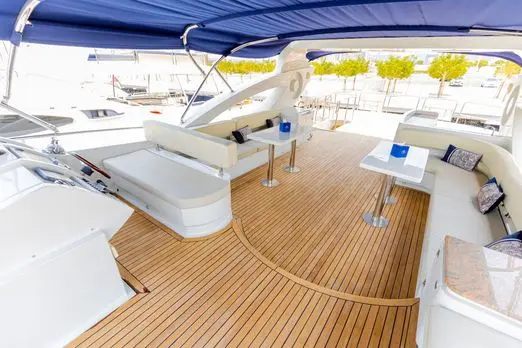 Asya 110 yacht aft deck seating area with teak flooring