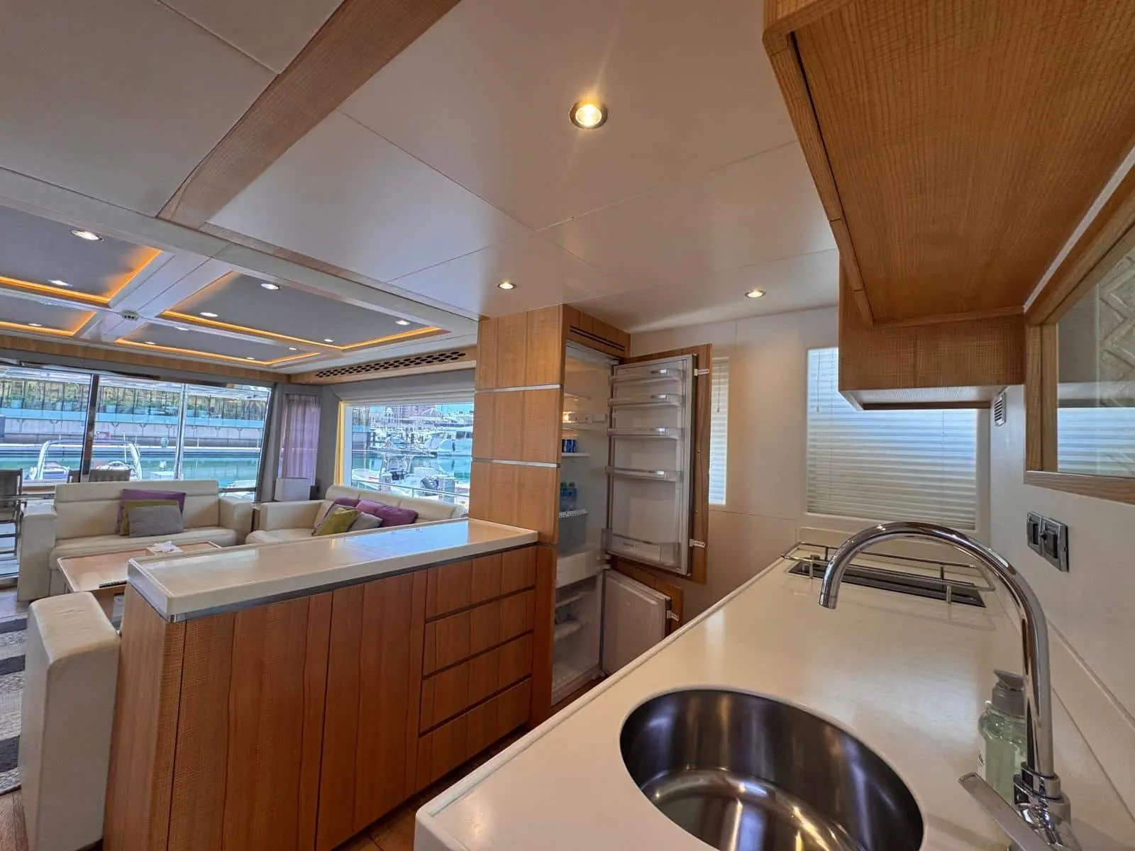 Nomad 65 galley with full-height fridge open to the saloon
