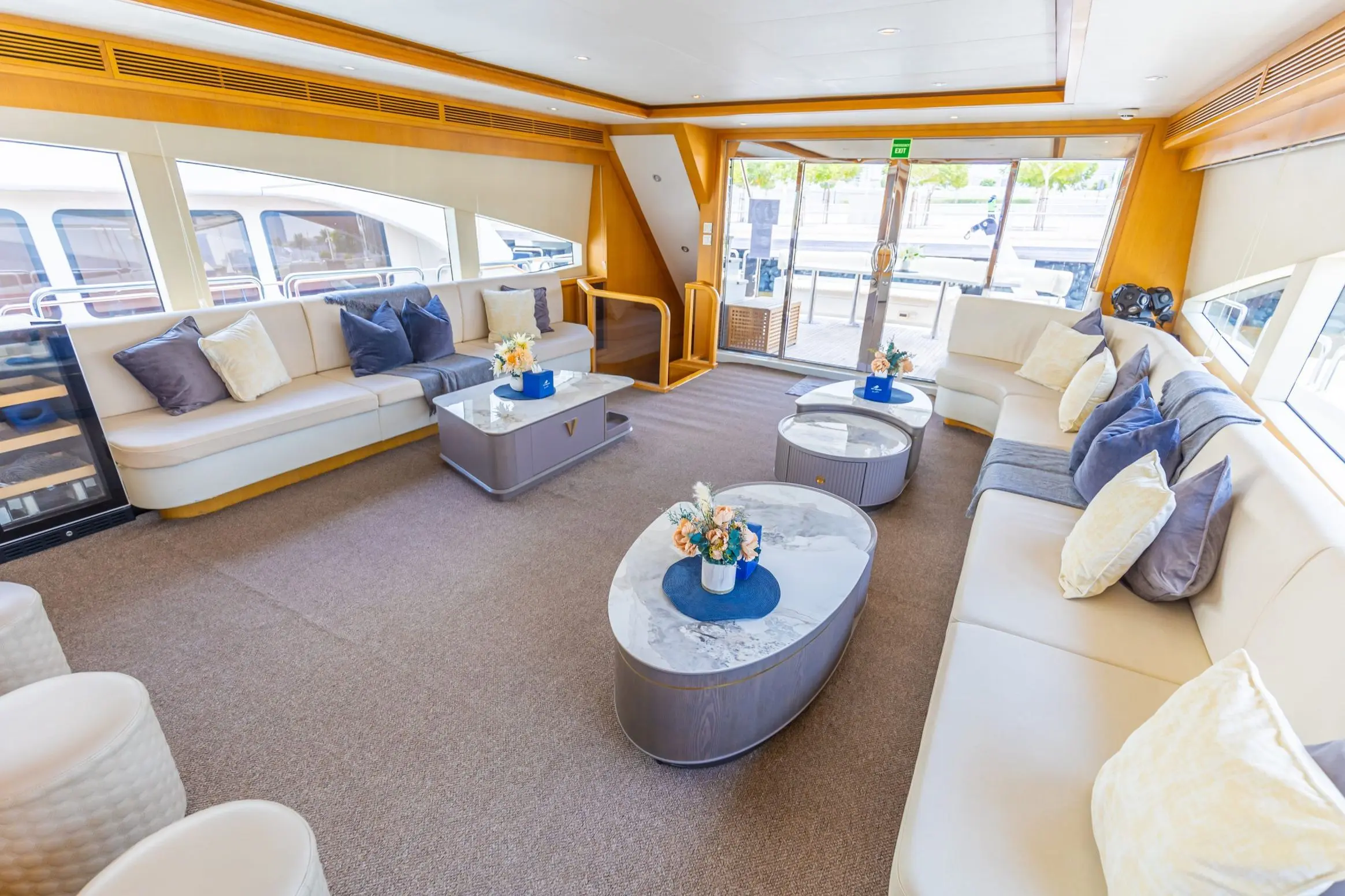 Asya 110 yacht indoor lounge with round coffee table and blue seating