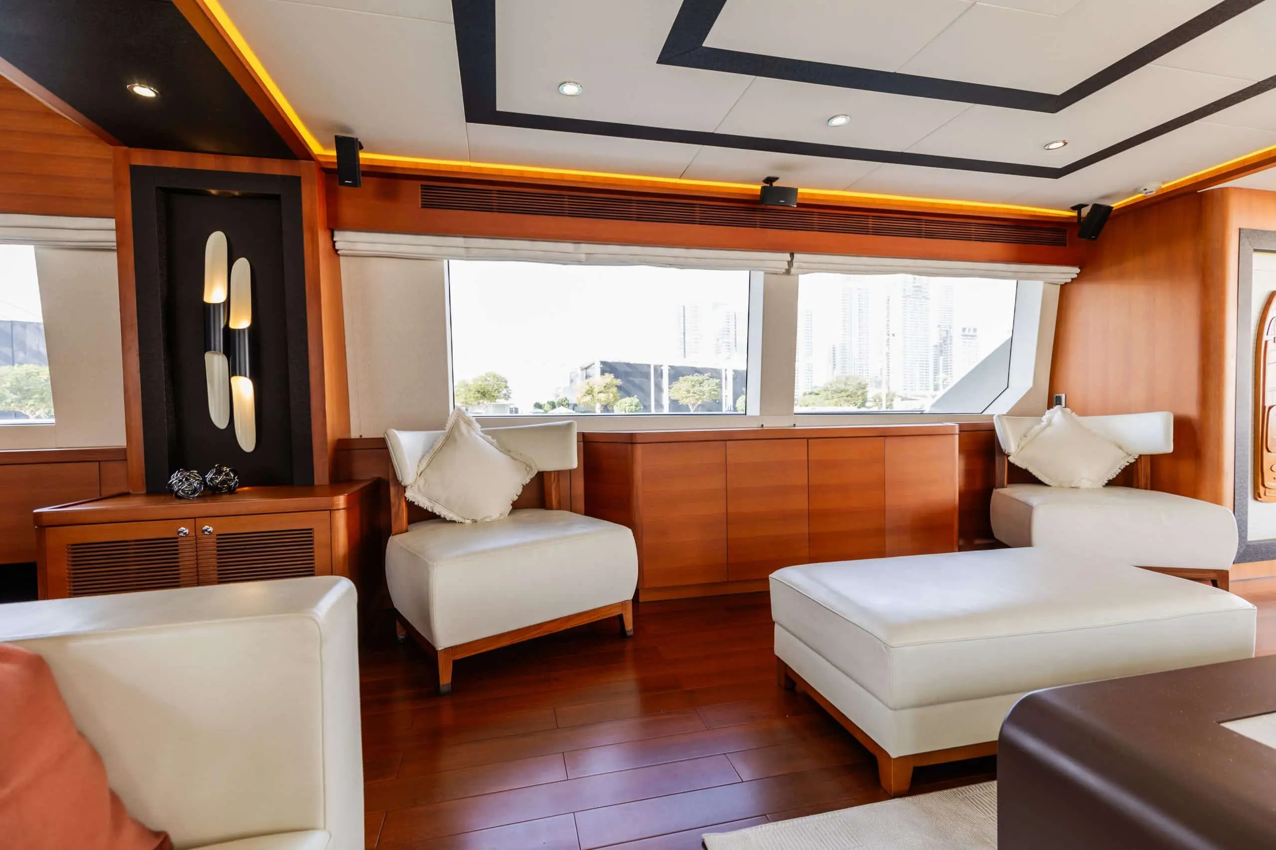 Cante 97 yacht guest cabin with wooden cabinetry and seating area