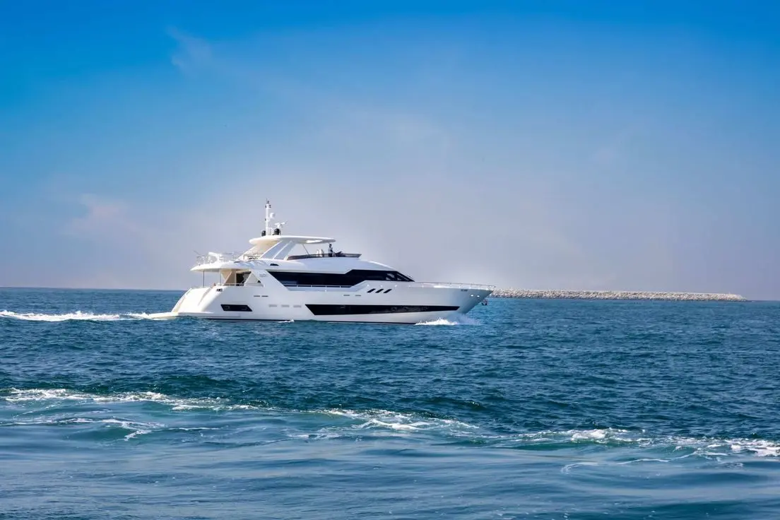 Cante 97 yacht cruising in Dubai Marina with skyline background