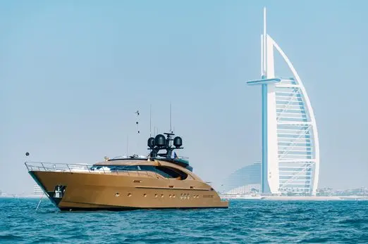 Royalty 136 luxury yacht cruising near Burj Al Arab in Dubai