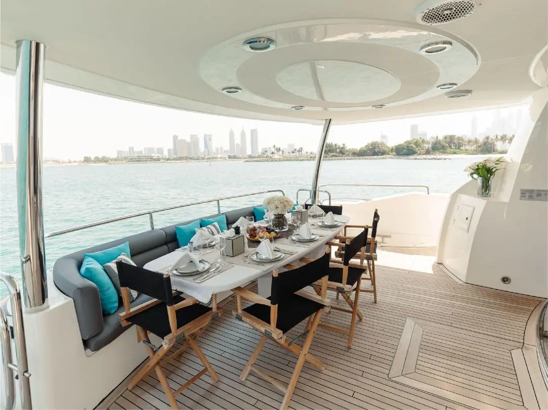 Outdoor dining area on Notorious yacht with shaded table setup