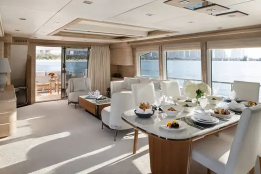 Luxury yacht indoor dining table setup with sea view in Dubai