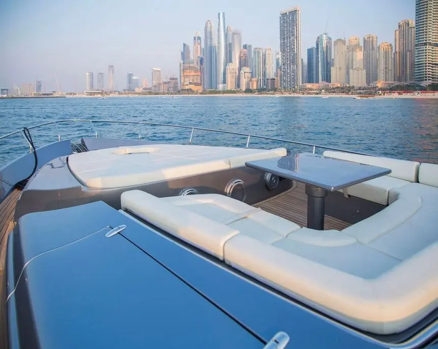 Pershing 82 foredeck lounge and table facing the Dubai skyline
