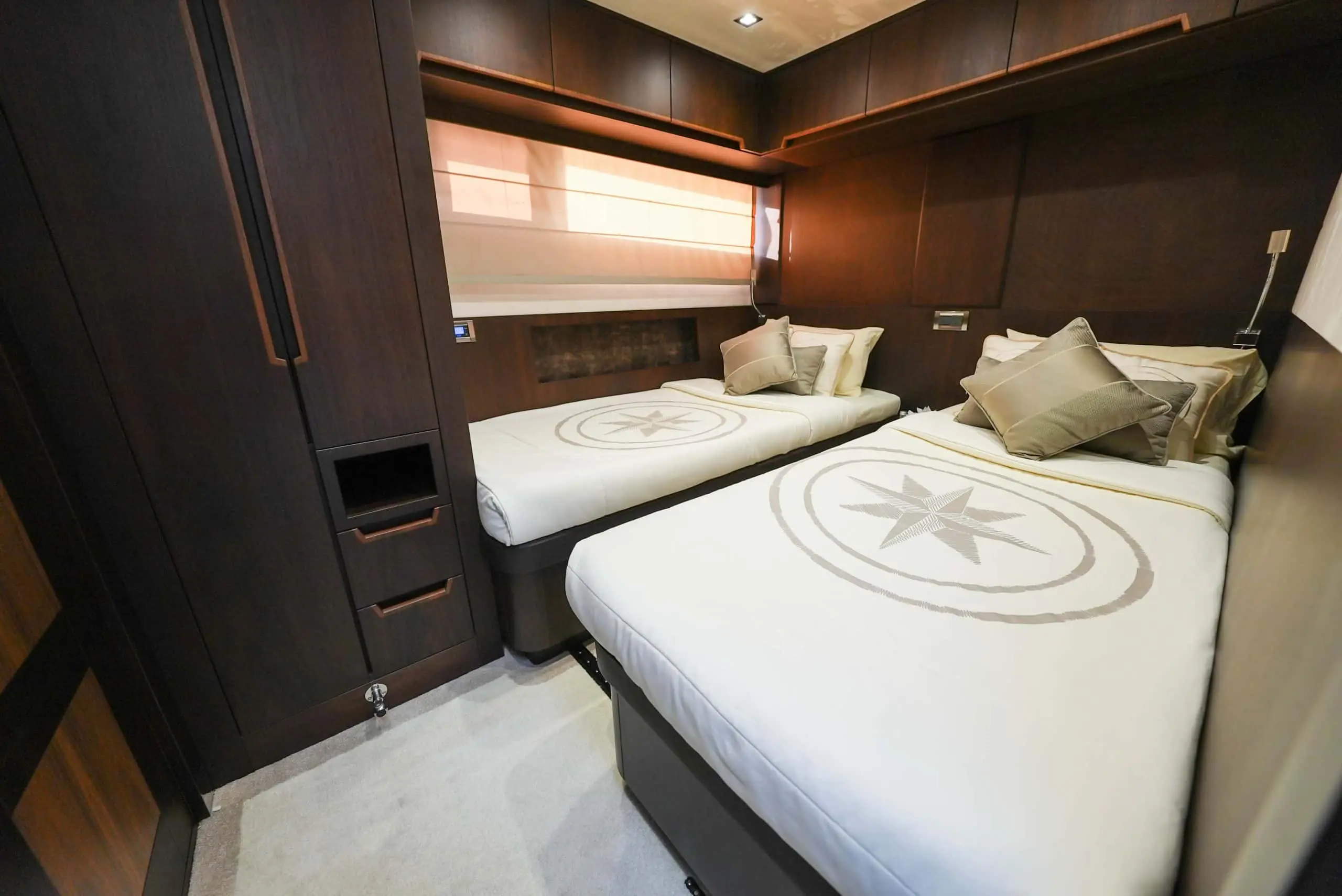 Galeon 780 F1 twin guest cabin with modern wood paneling and luxury bedding