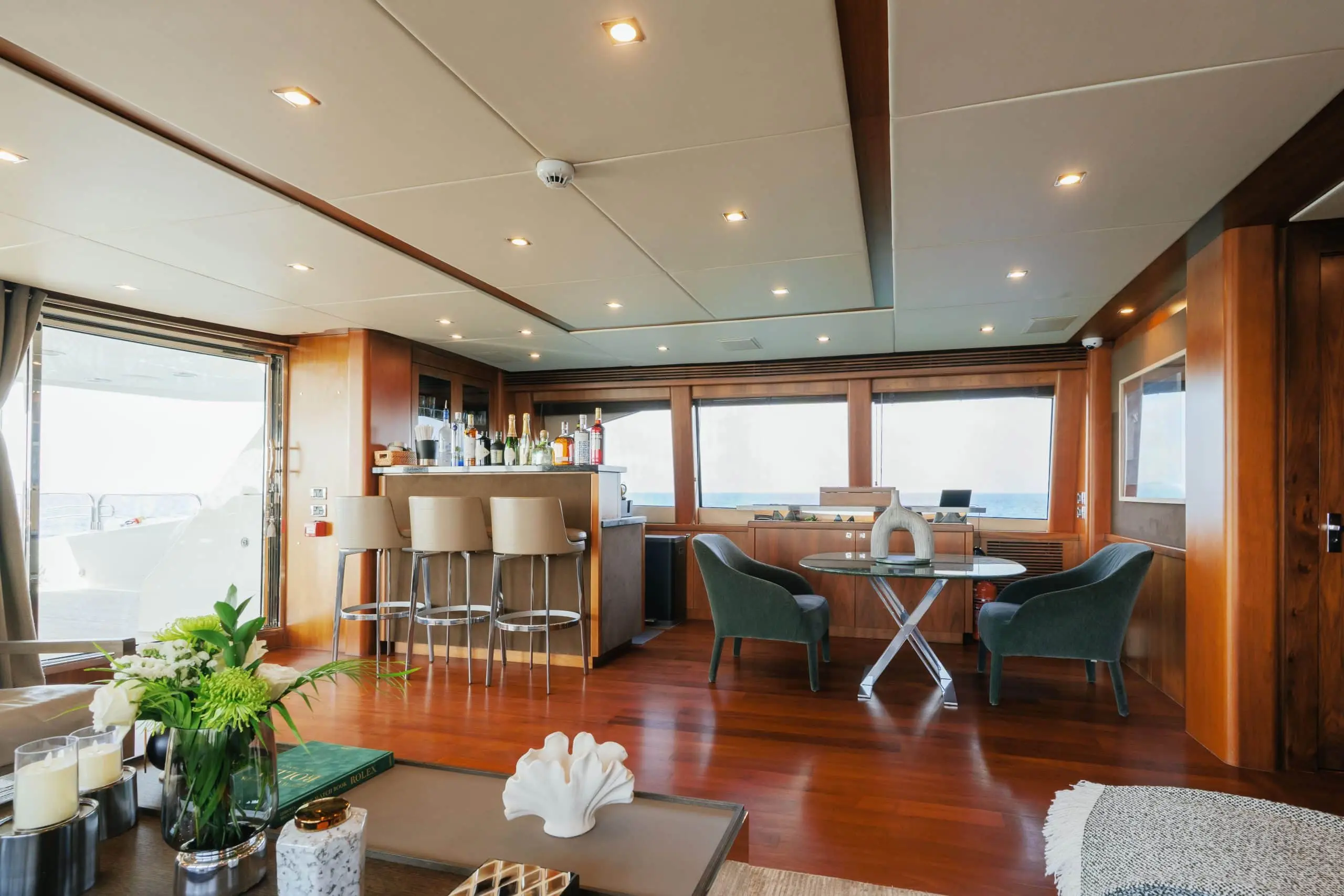 Aurora 130 yacht dining area with large windows and elegant table setting