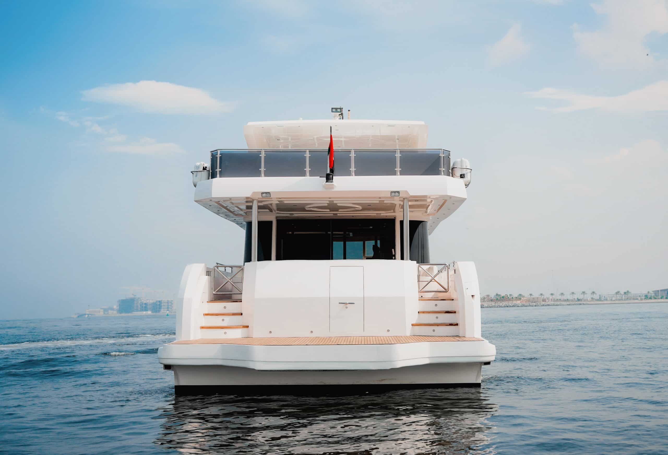 Carina 75 luxury yacht stern cruising on calm water in Dubai charter