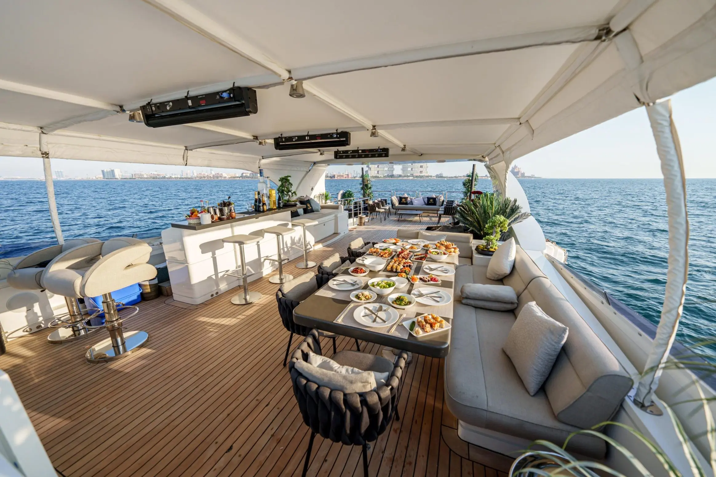 Tatti 110 yacht flybridge seating area with dining setup