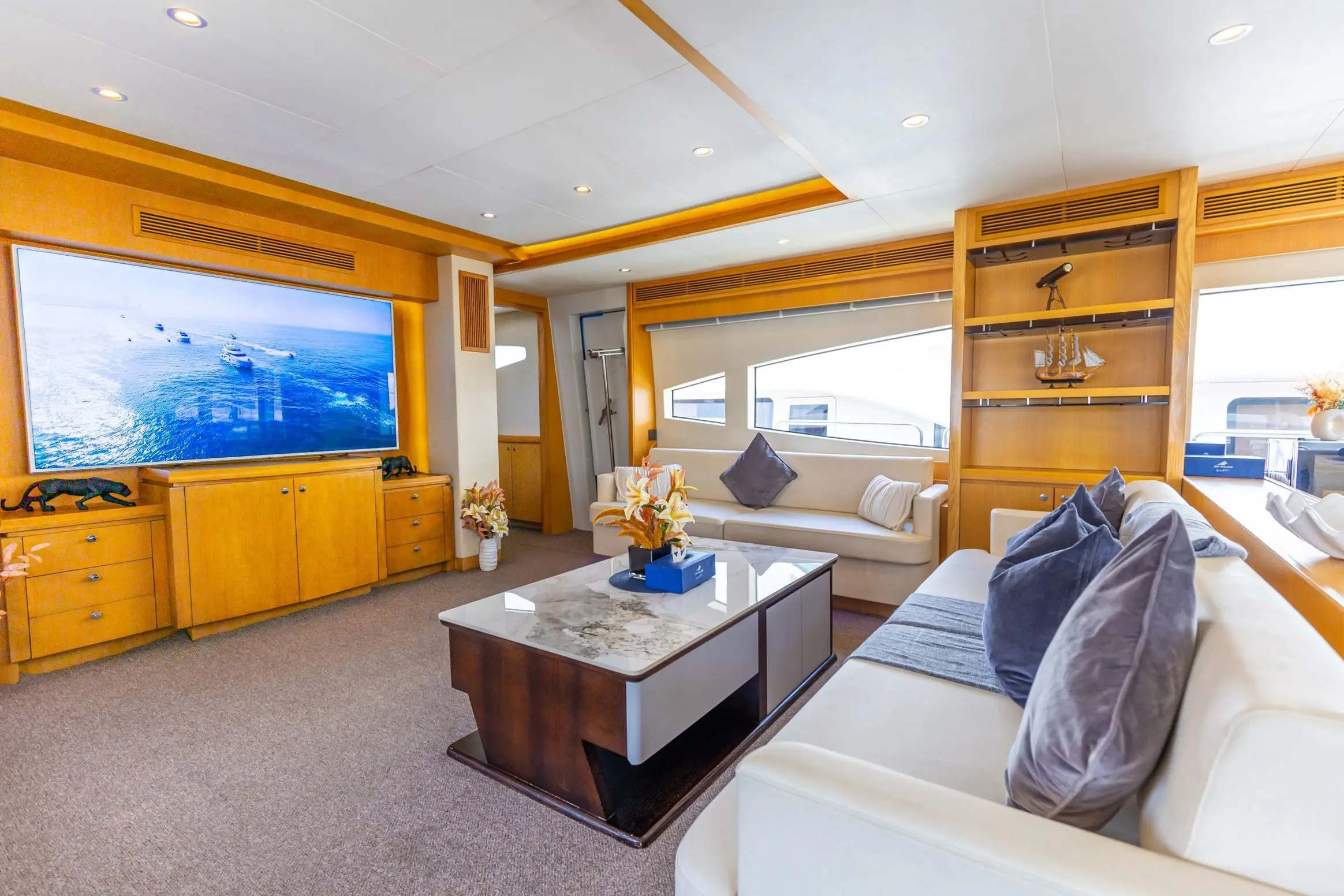 Asya 110 yacht lounge area with coffee table and large TV screen