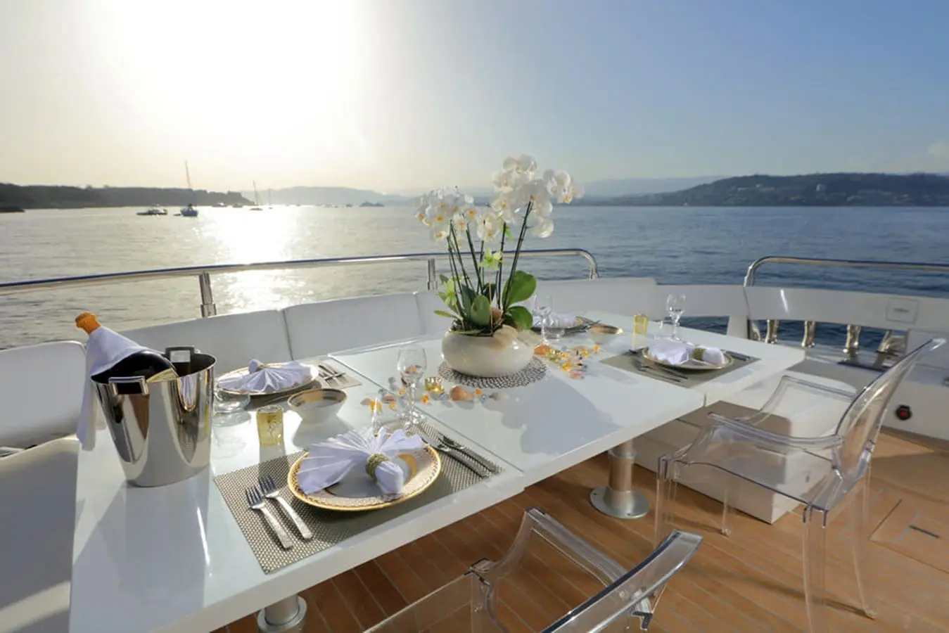 Baia 100 aft deck dining table set with champagne service