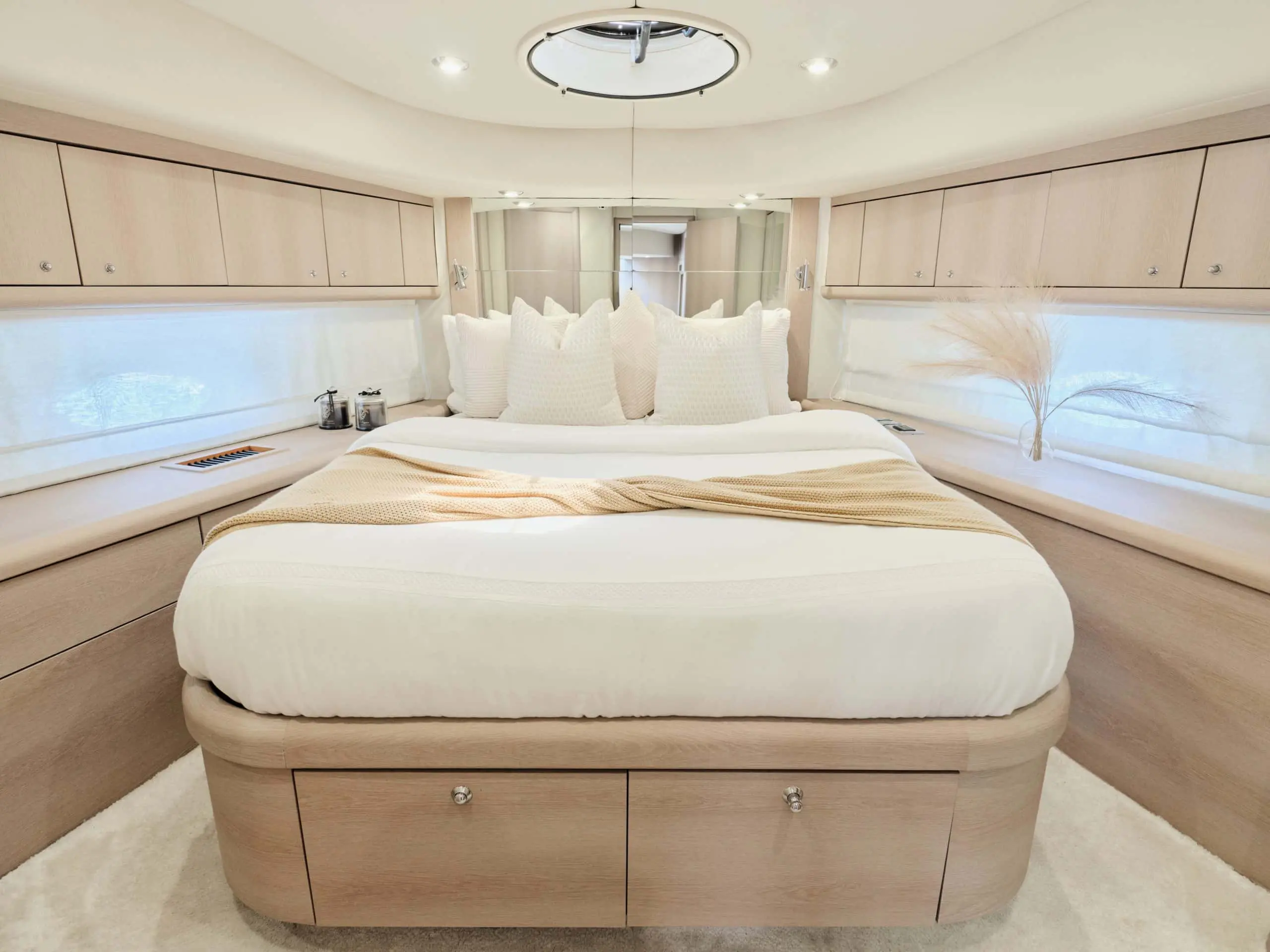 Sunseeker Satoshi 70 master bedroom cabin with large central bed and soft lighting