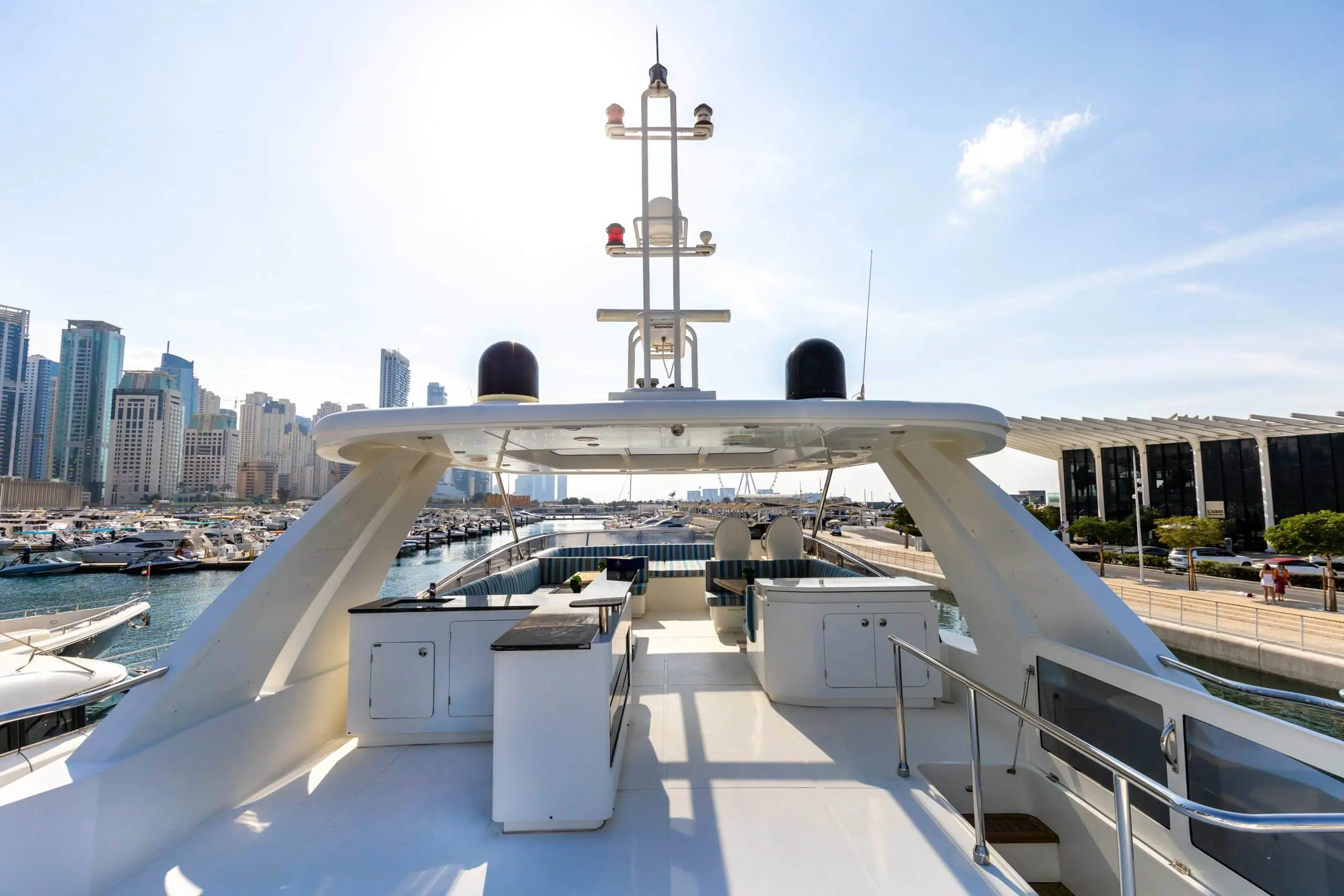 Cante 97 yacht upper deck lounge area with white seating and marina view