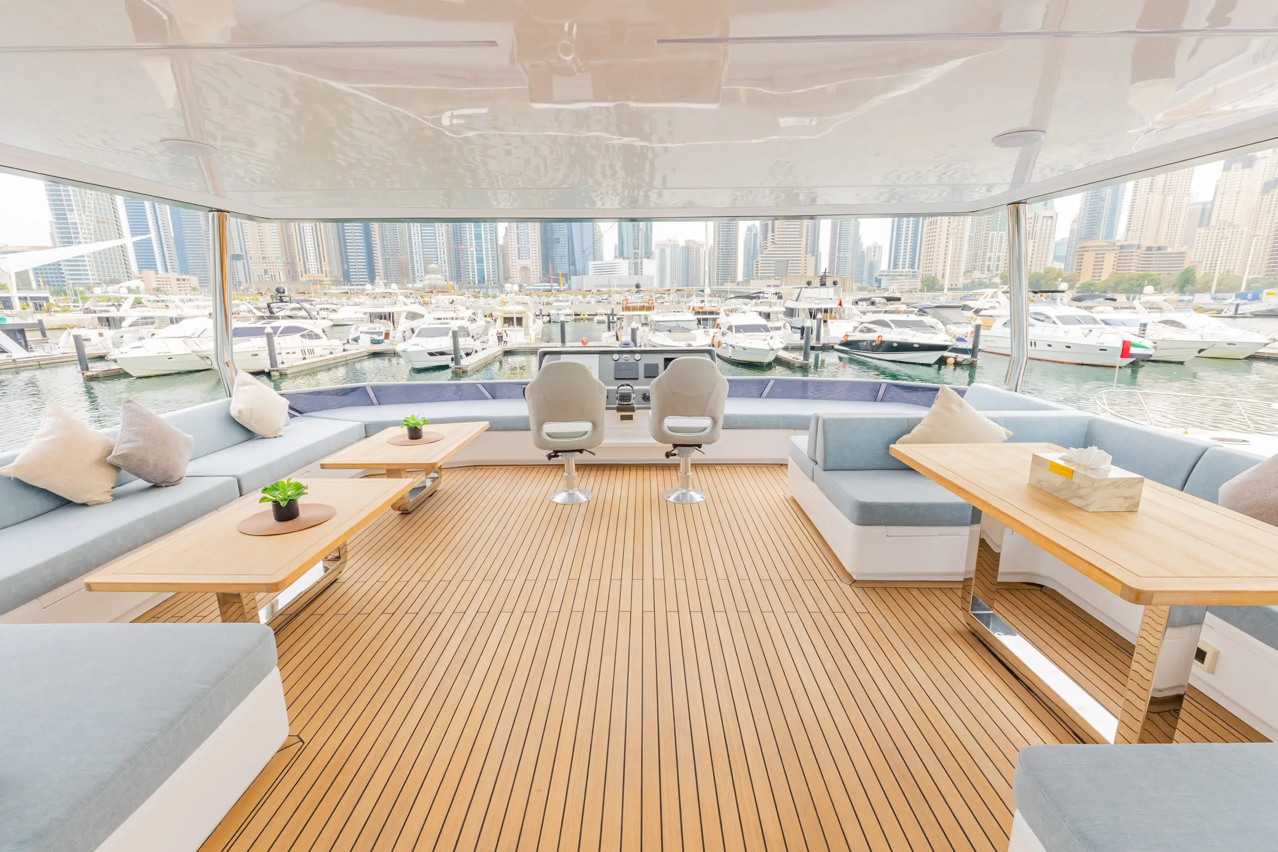 Zirve 72 yacht interior lounge with curved sofa and entertainment setup