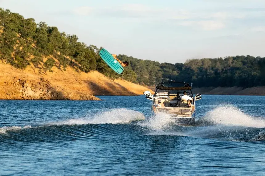Supreme S240 stern view running with a wakeboarder — press photo