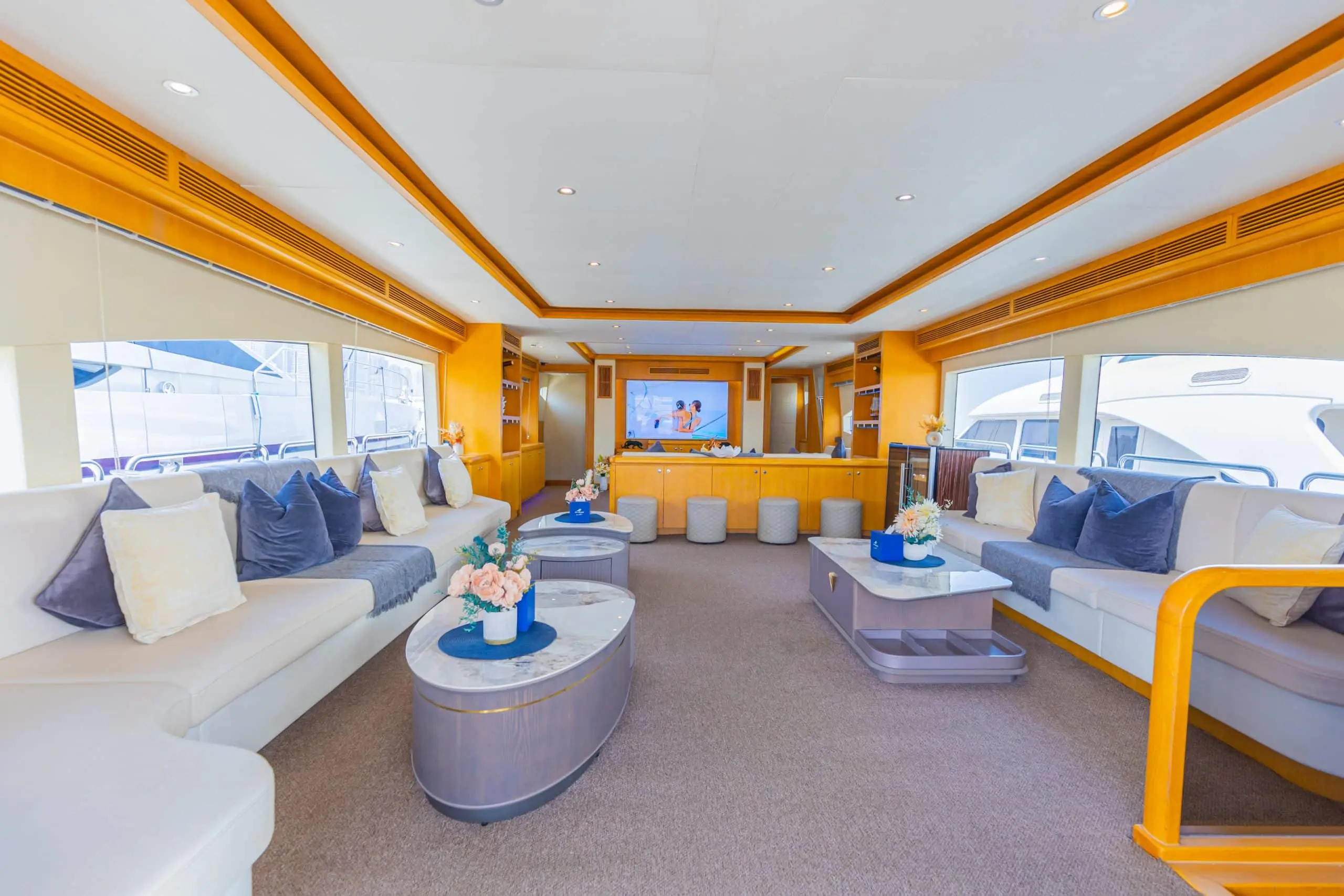 Asya 110 yacht main salon with blue sofas and panoramic windows