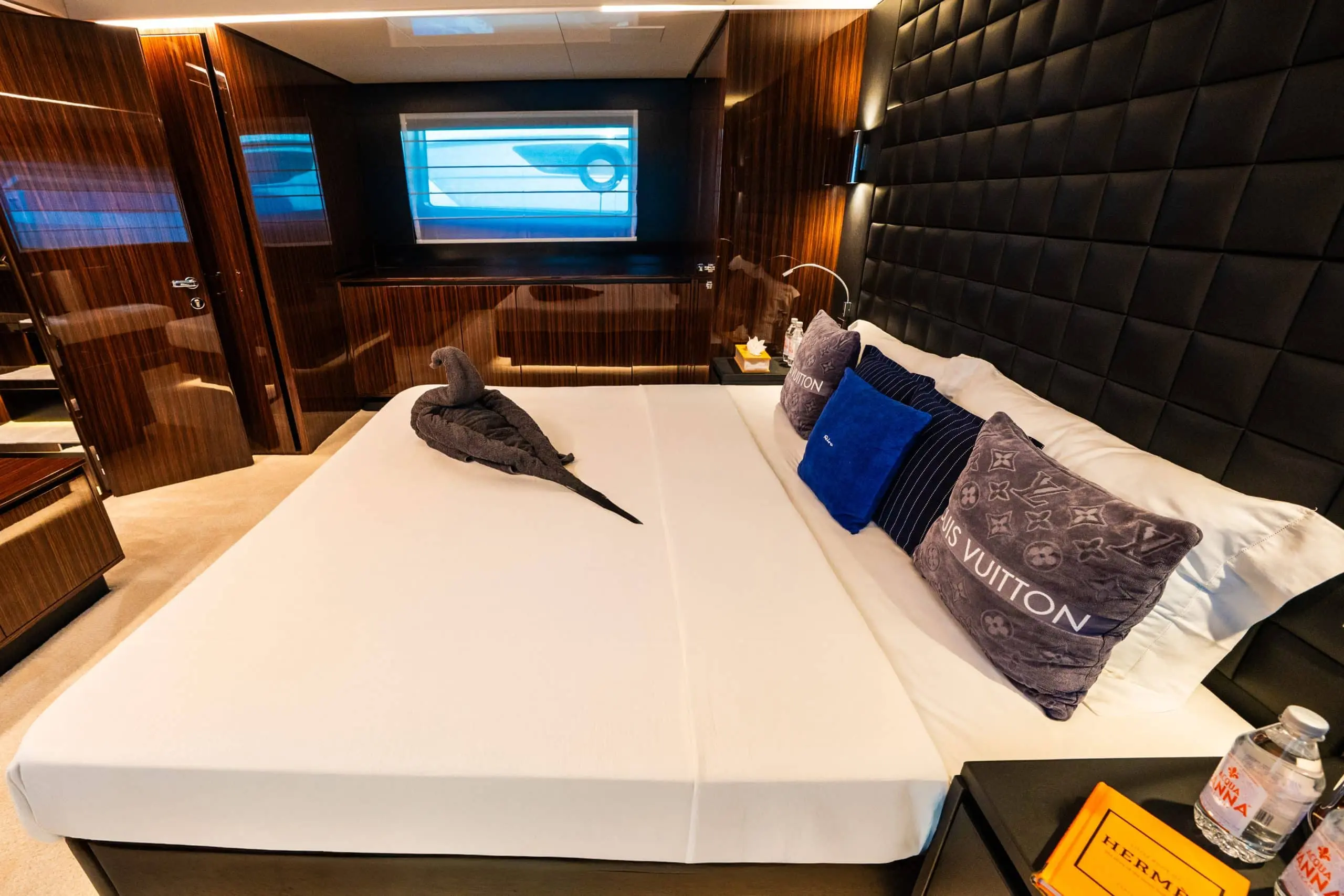 Riva 82 F1 yacht luxury master cabin with king-size bed, designer cushions, panoramic sea-view window, and premium wood panel interior