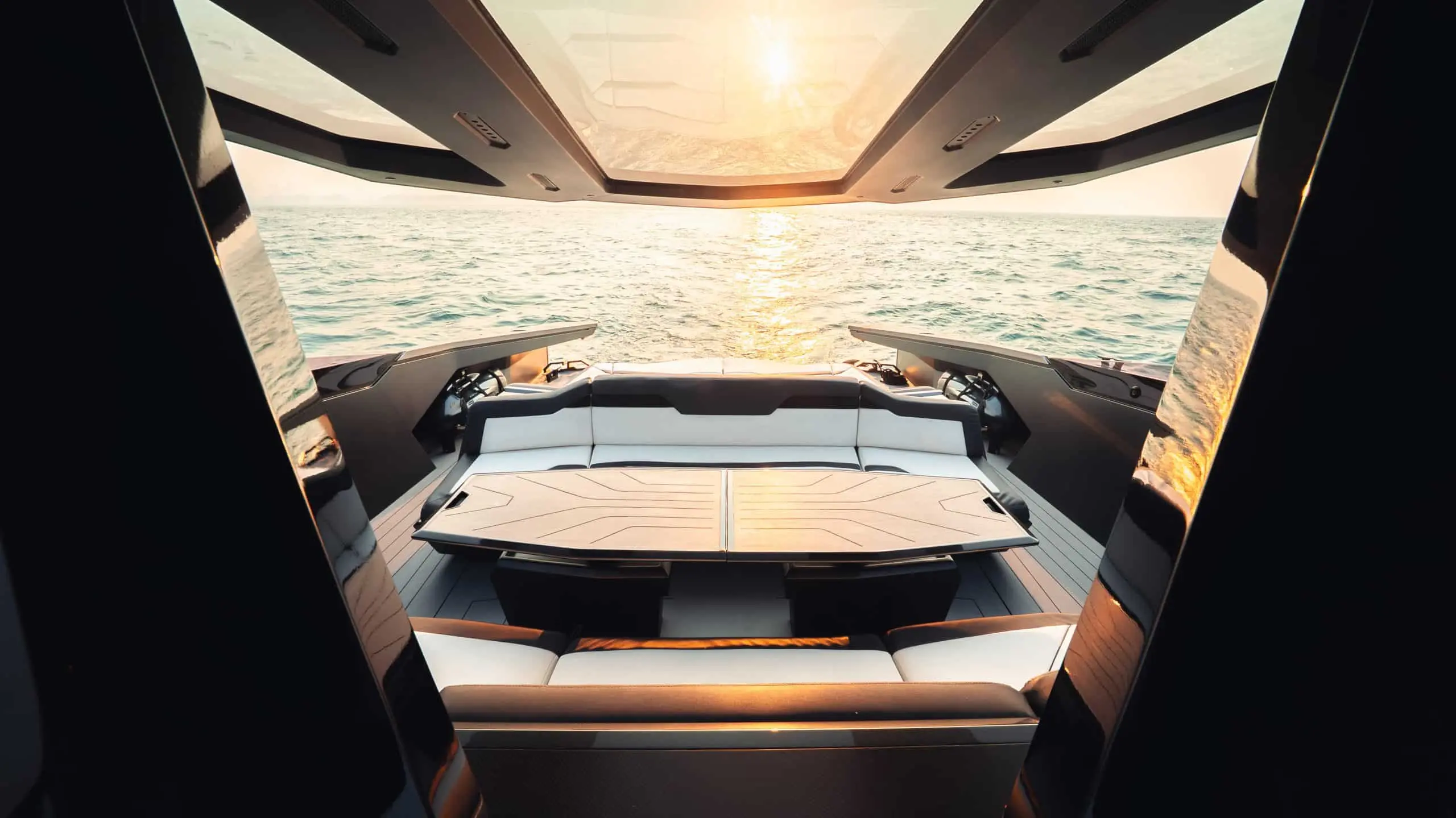 Lamborghini 63 yacht rear sun deck with luxury sunpad overlooking the sea at sunset